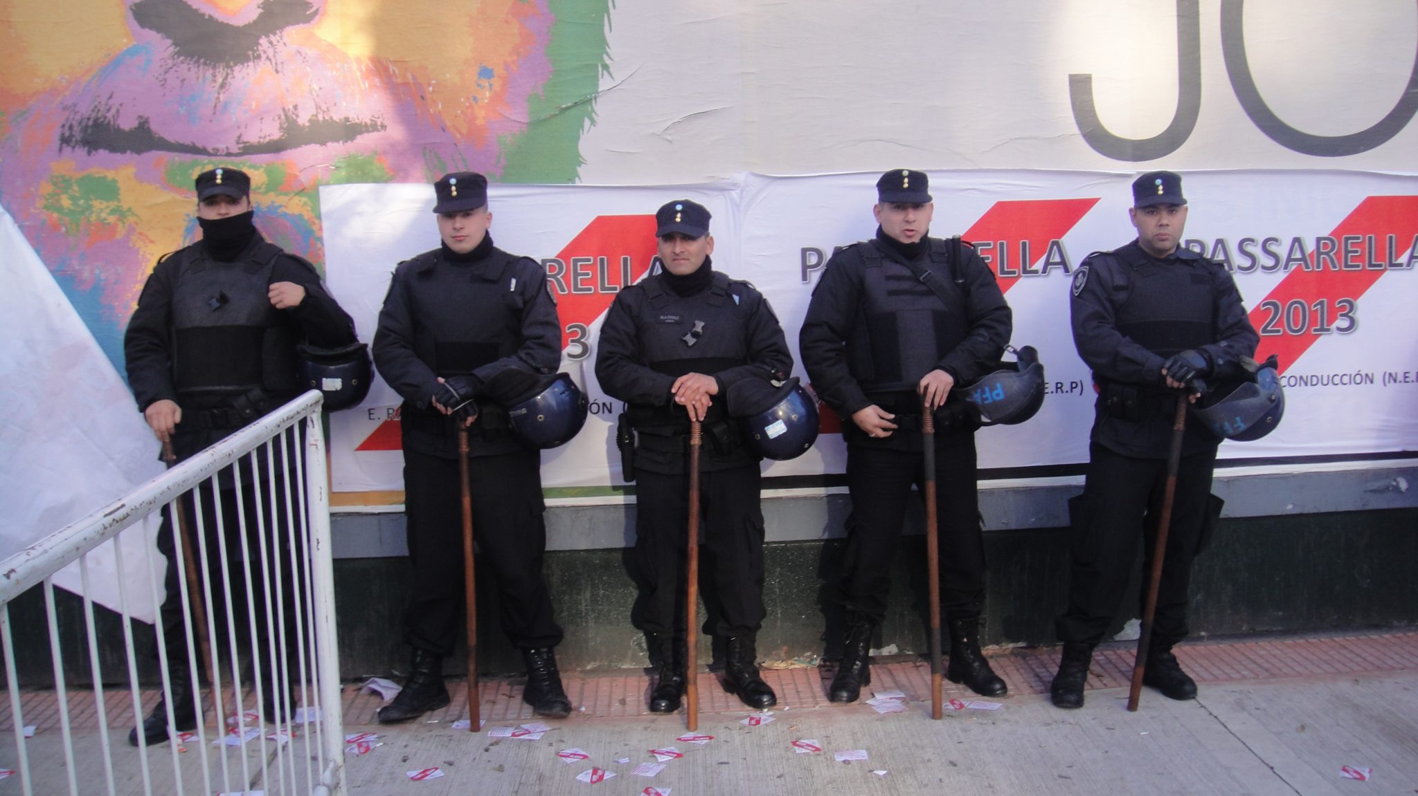a group of police officers standing in front of a sign