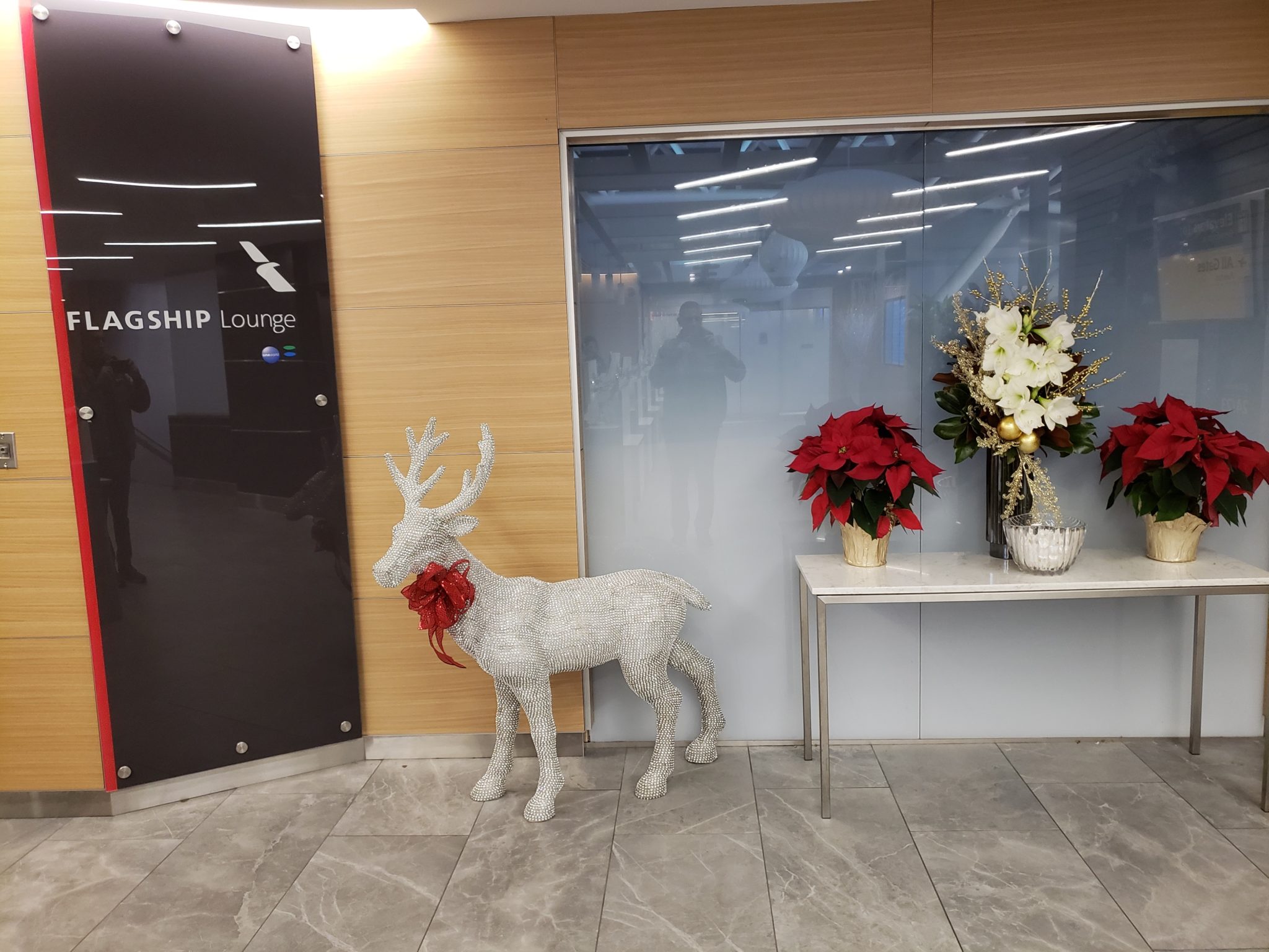 a reindeer statue in front of a glass door
