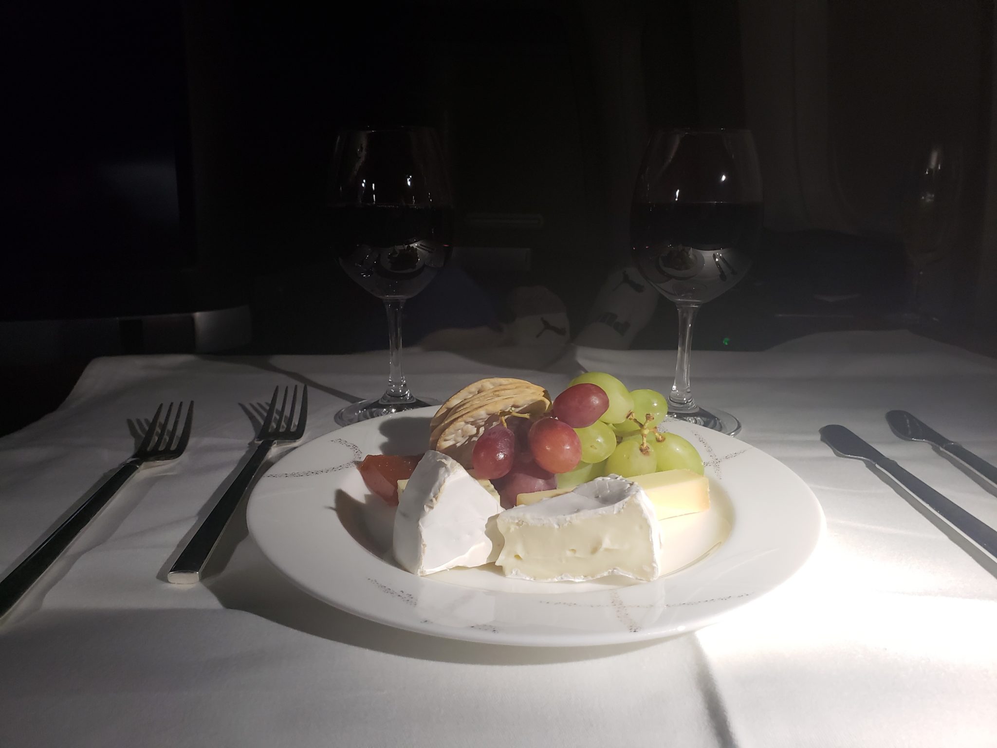 a plate of food and wine glasses on a table