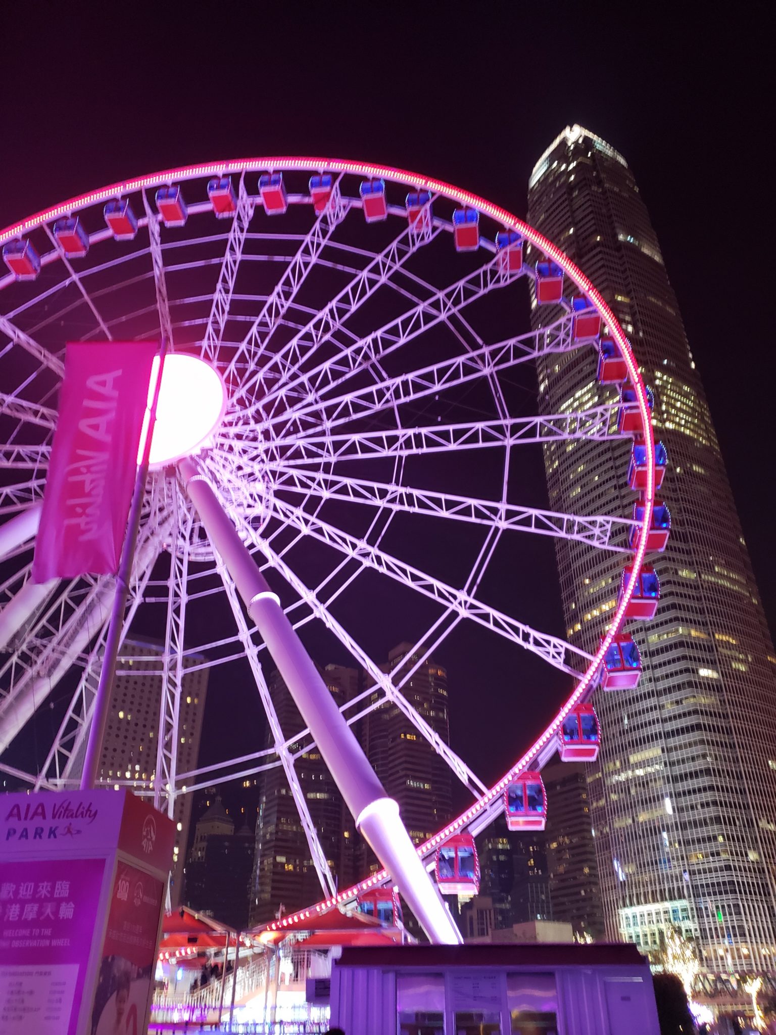 a ferris wheel in front of a tall building