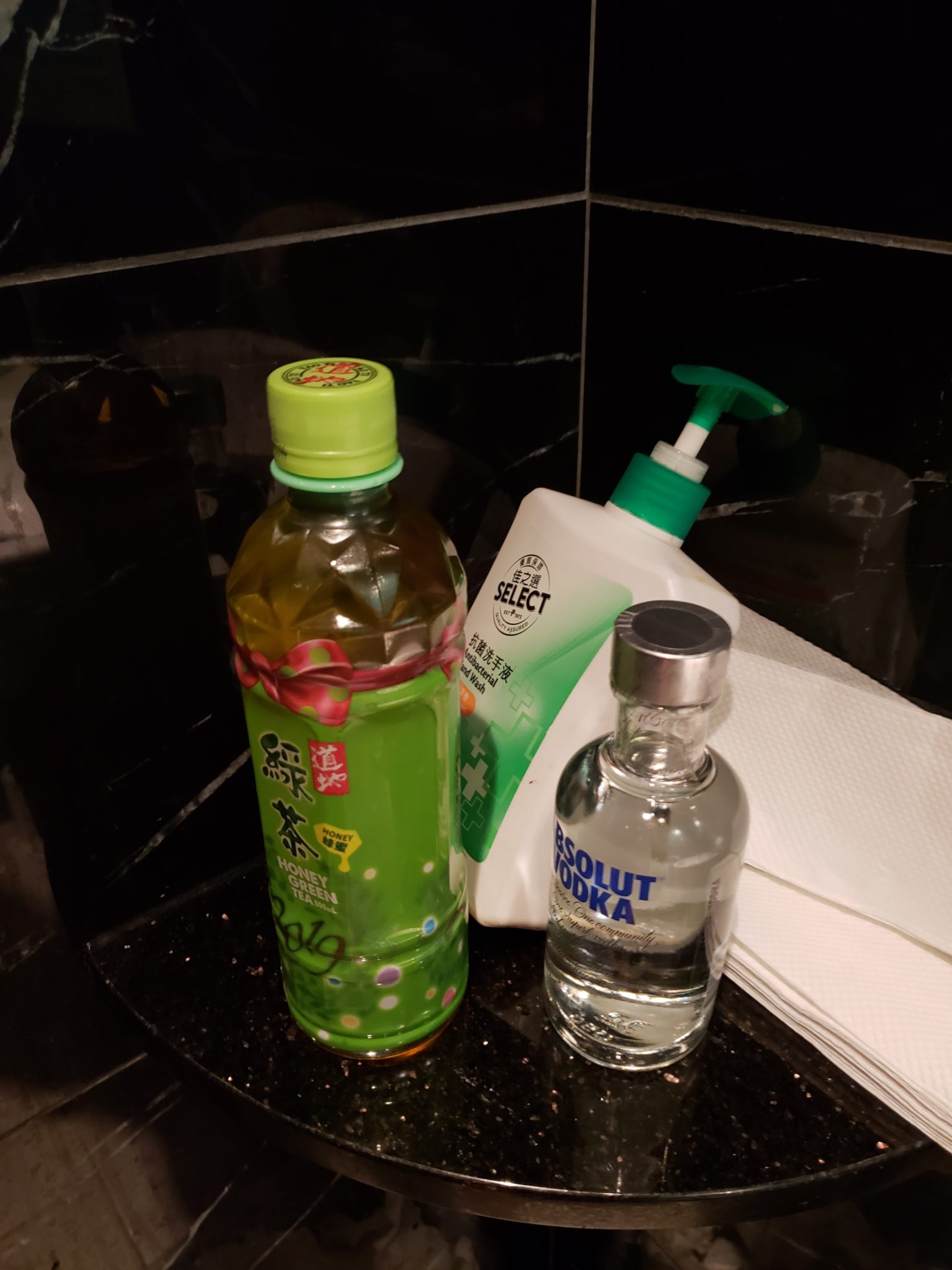 a group of bottles of liquid and a bottle of alcohol