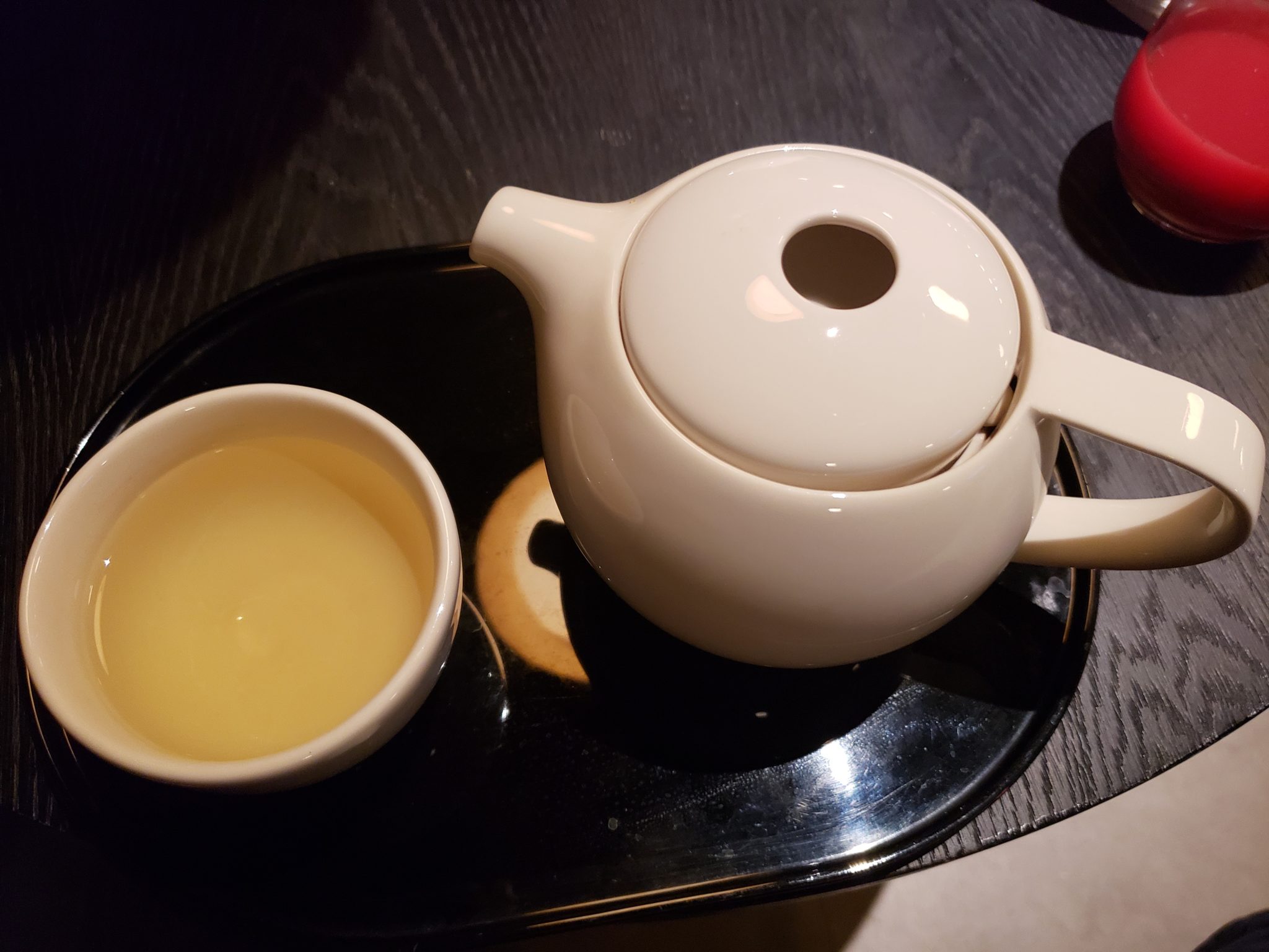 a teapot and a cup on a tray