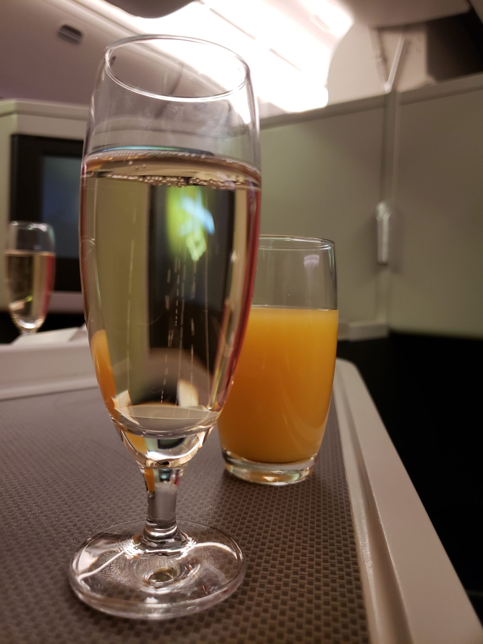 a glass of champagne next to a glass of orange juice