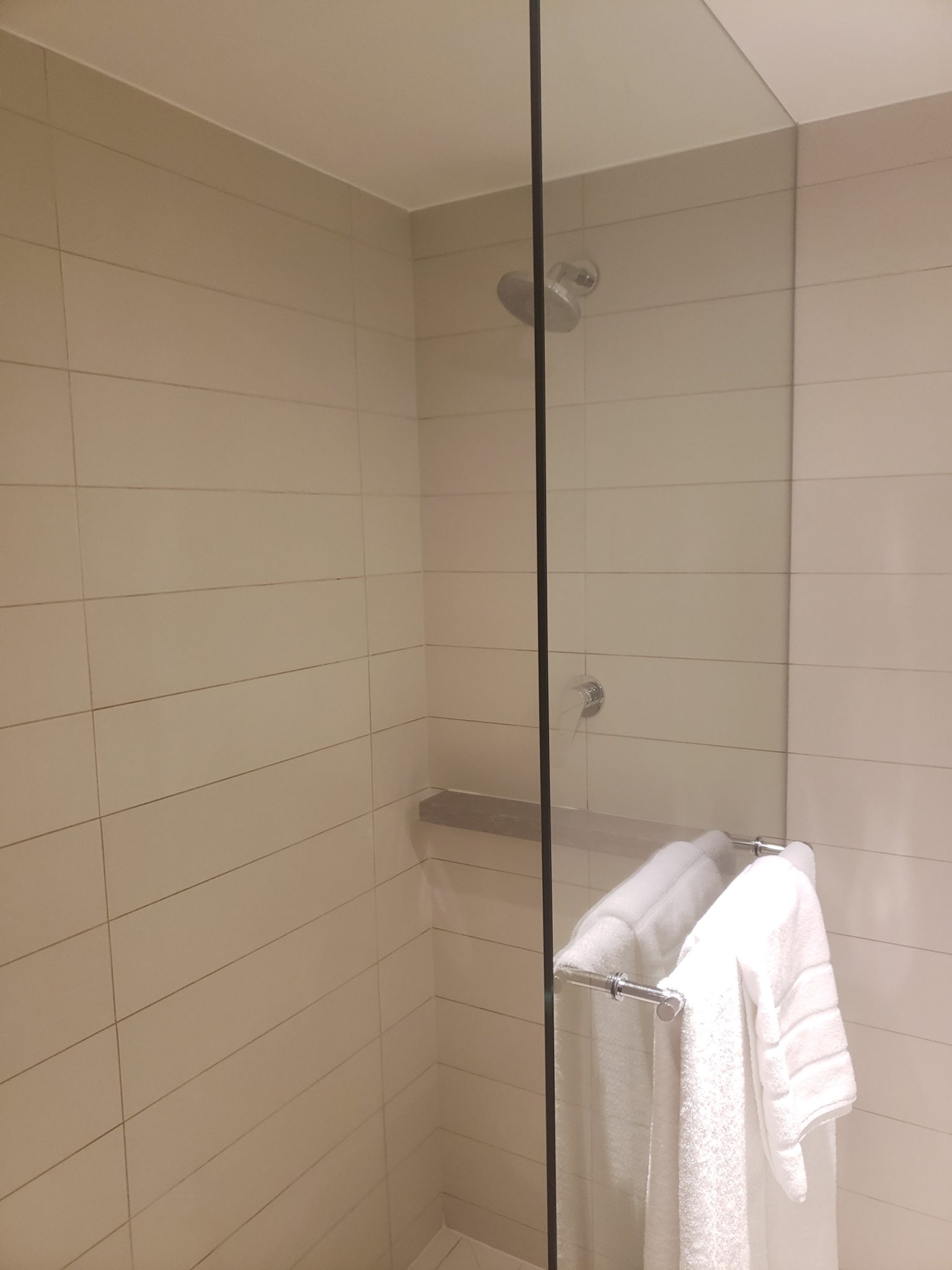 a shower with a towel on a rack