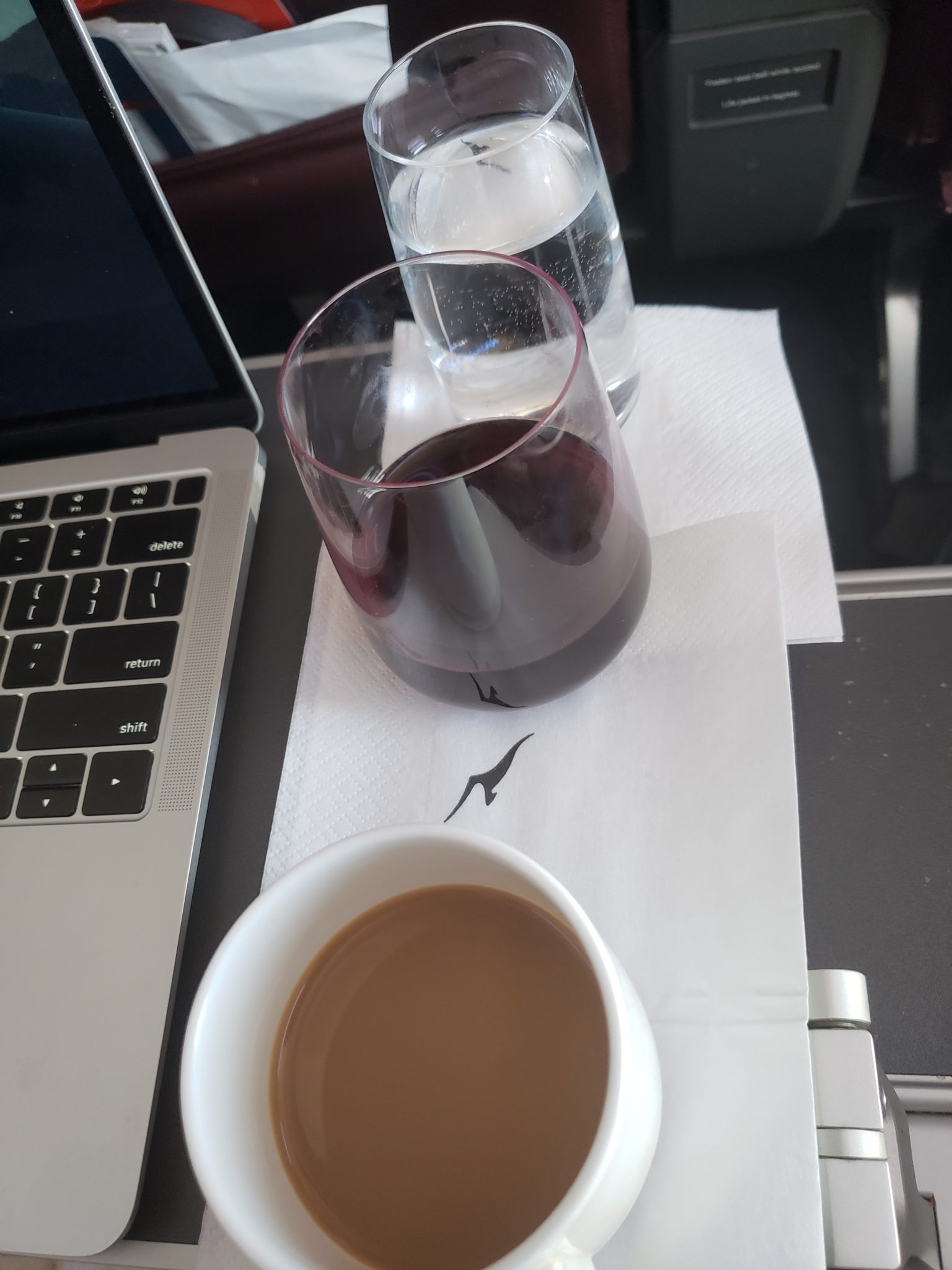 a cup of coffee and a glass of liquid on a napkin