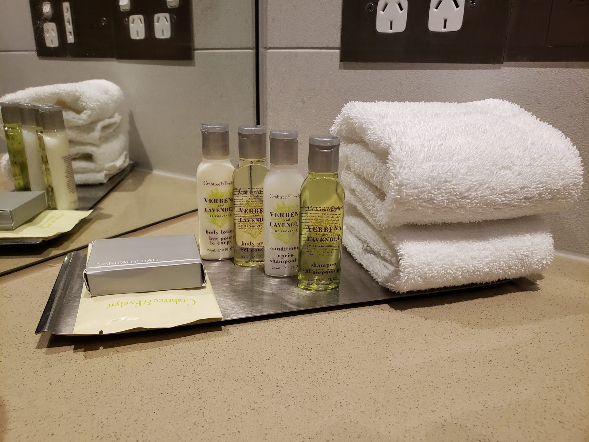 a group of small bottles of shampoo and towels