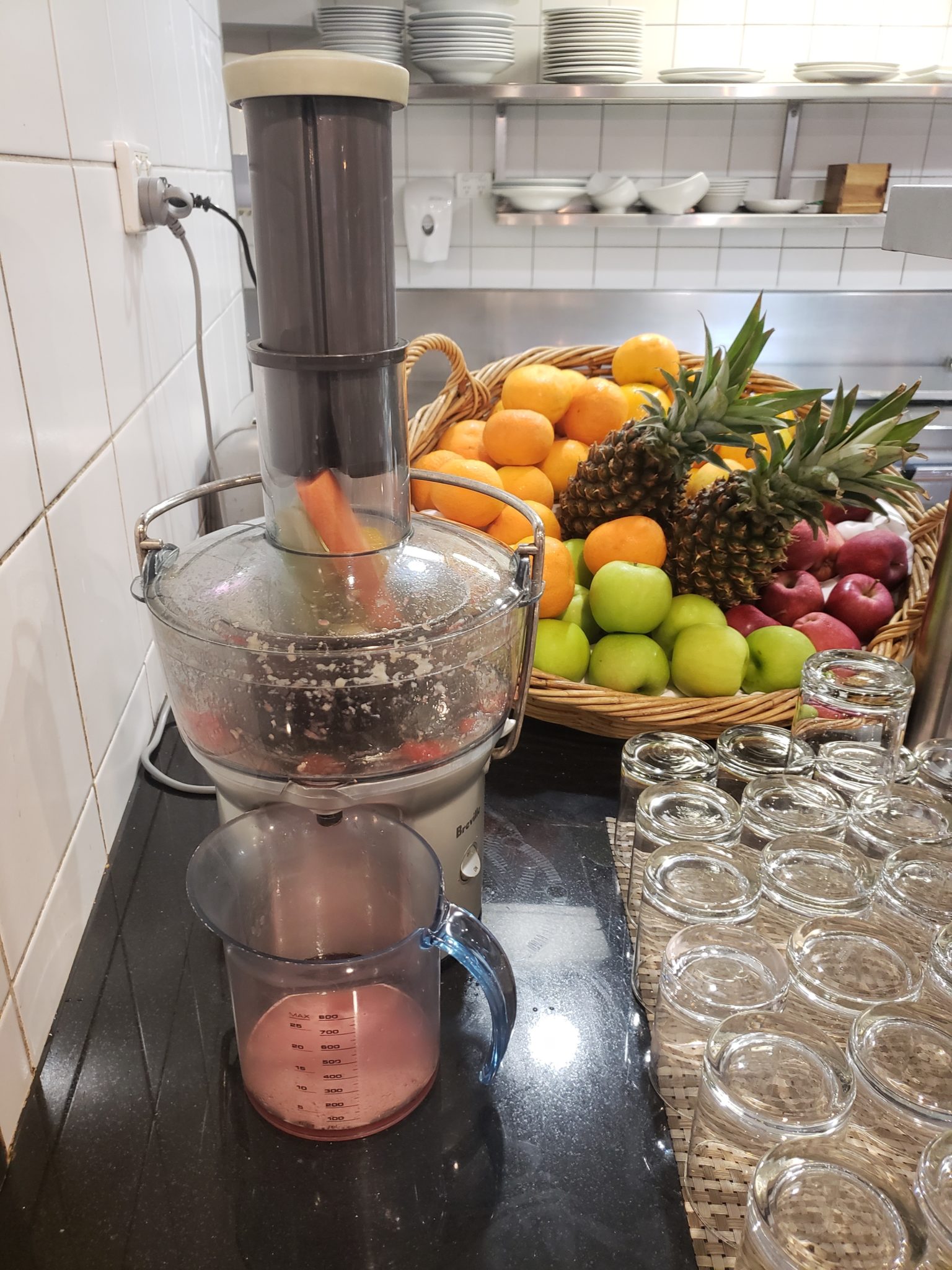 a juicer and fruit in a basket