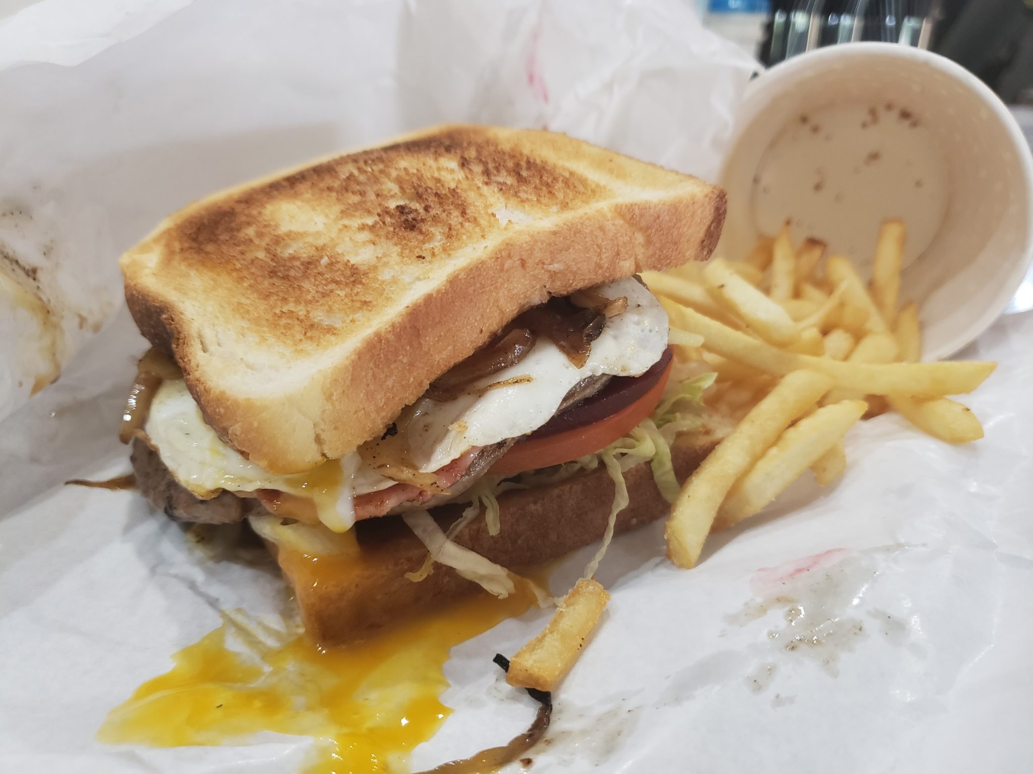 a sandwich with fries and sauce