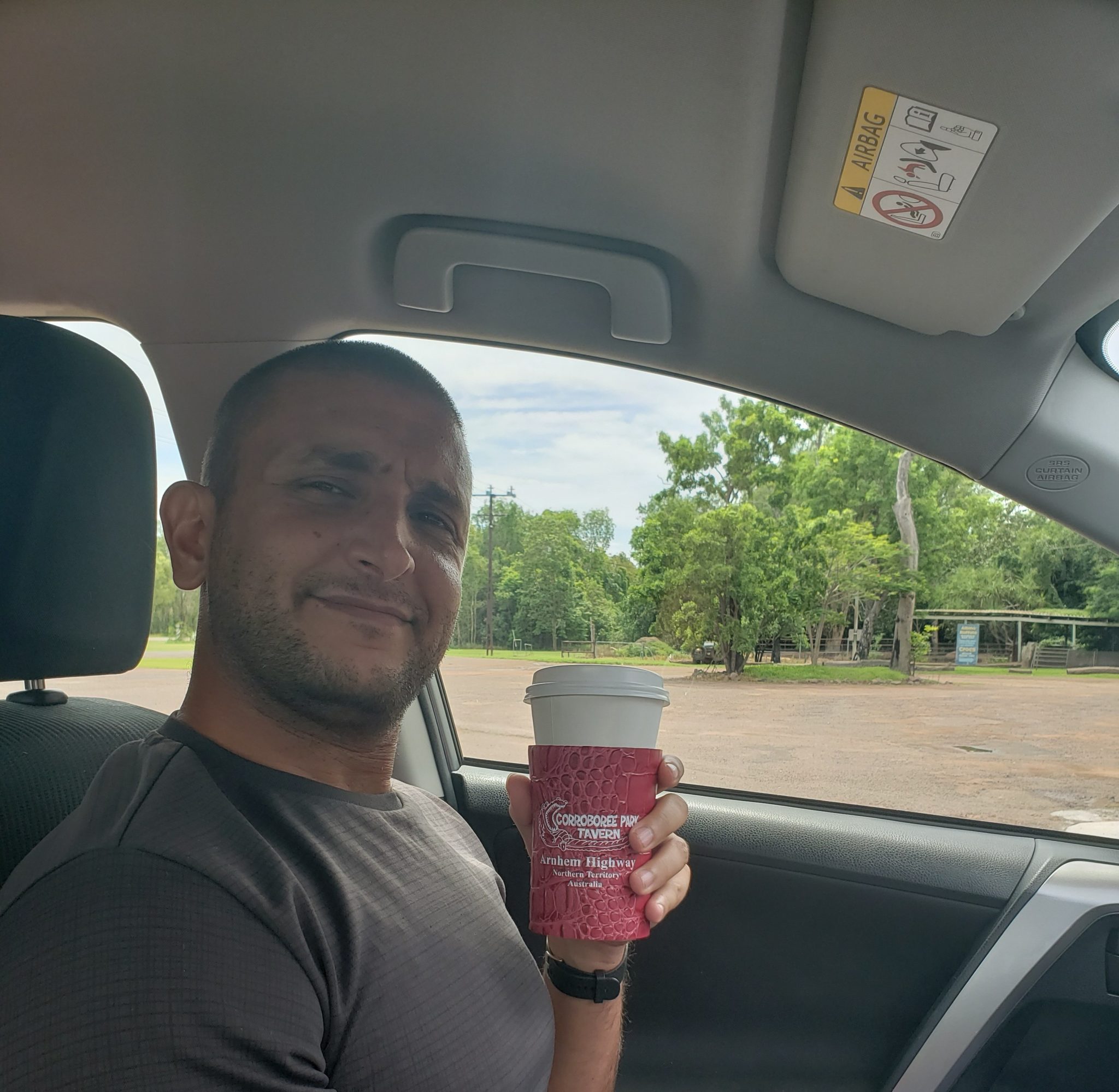 a man holding a red cup in a car