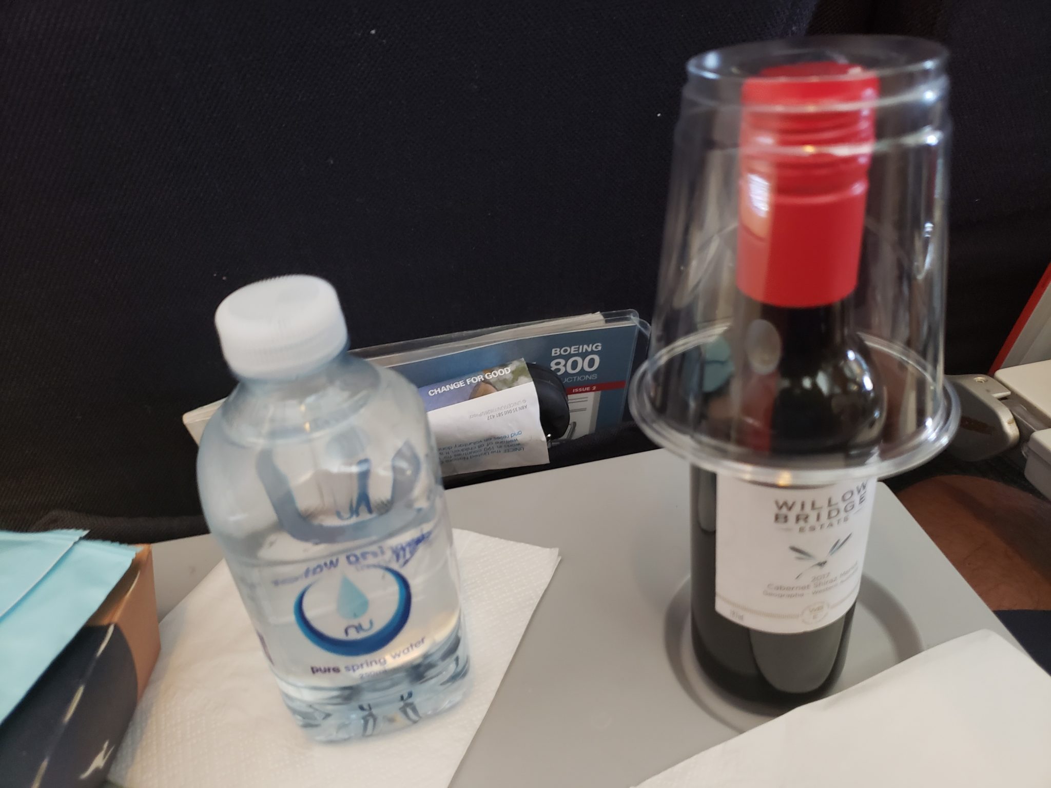 a bottle of wine and a bottle of water on a tray
