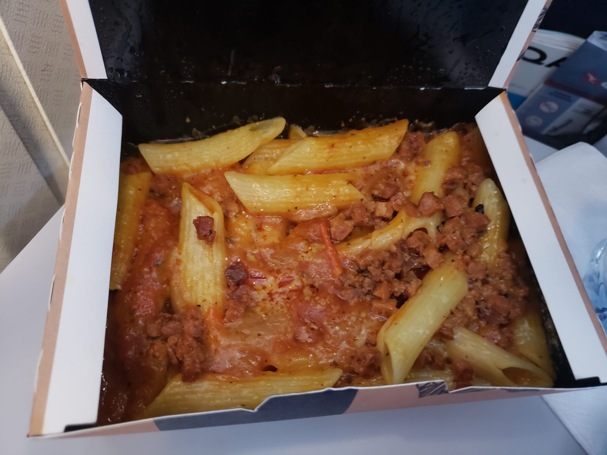 a box of pasta with meat and sauce