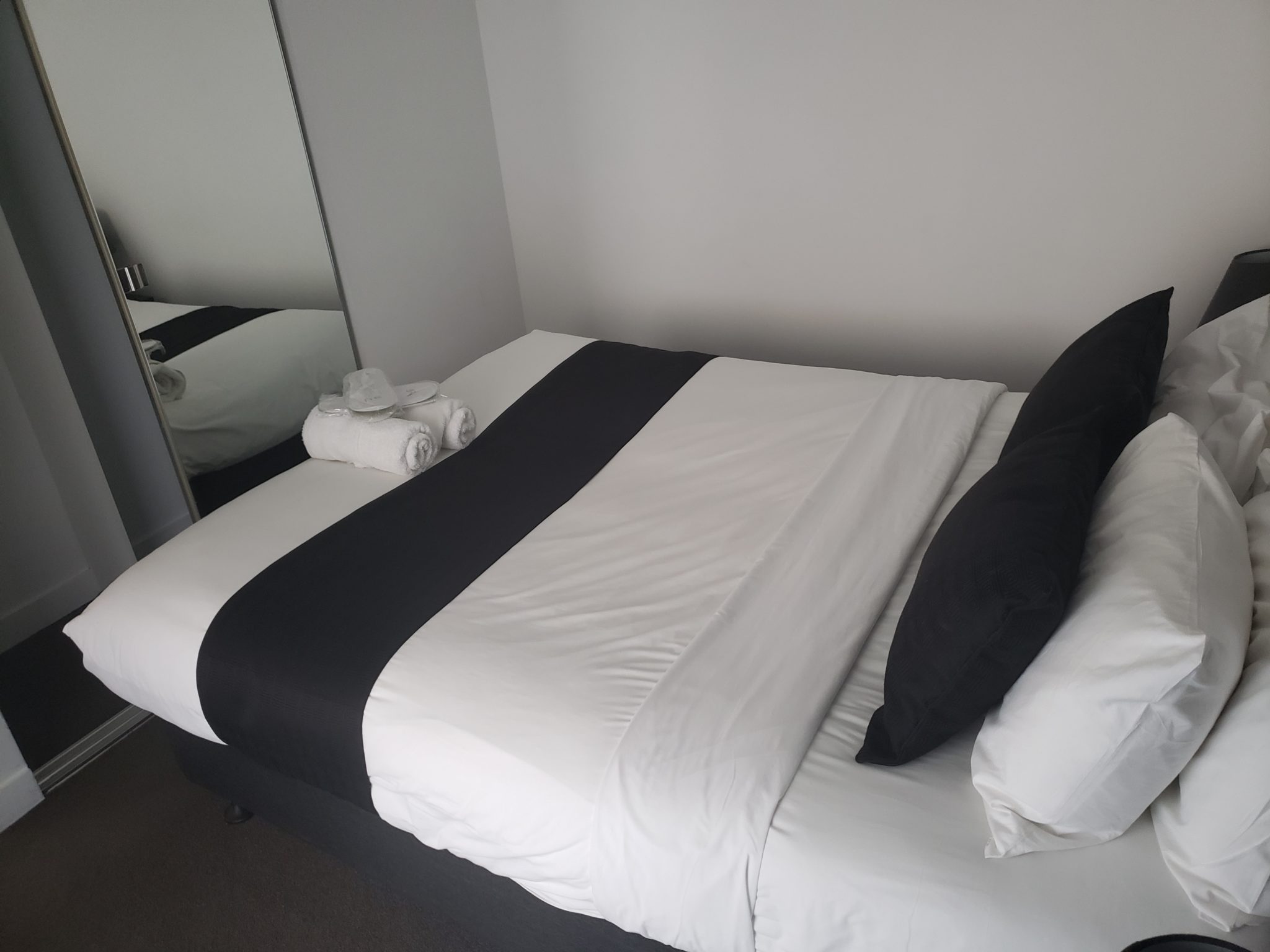 a bed with black and white sheets
