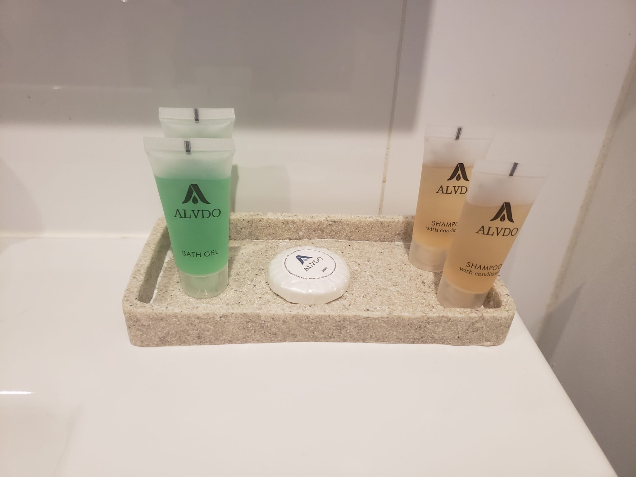 a group of small bottles of shampoo and soap on a tray