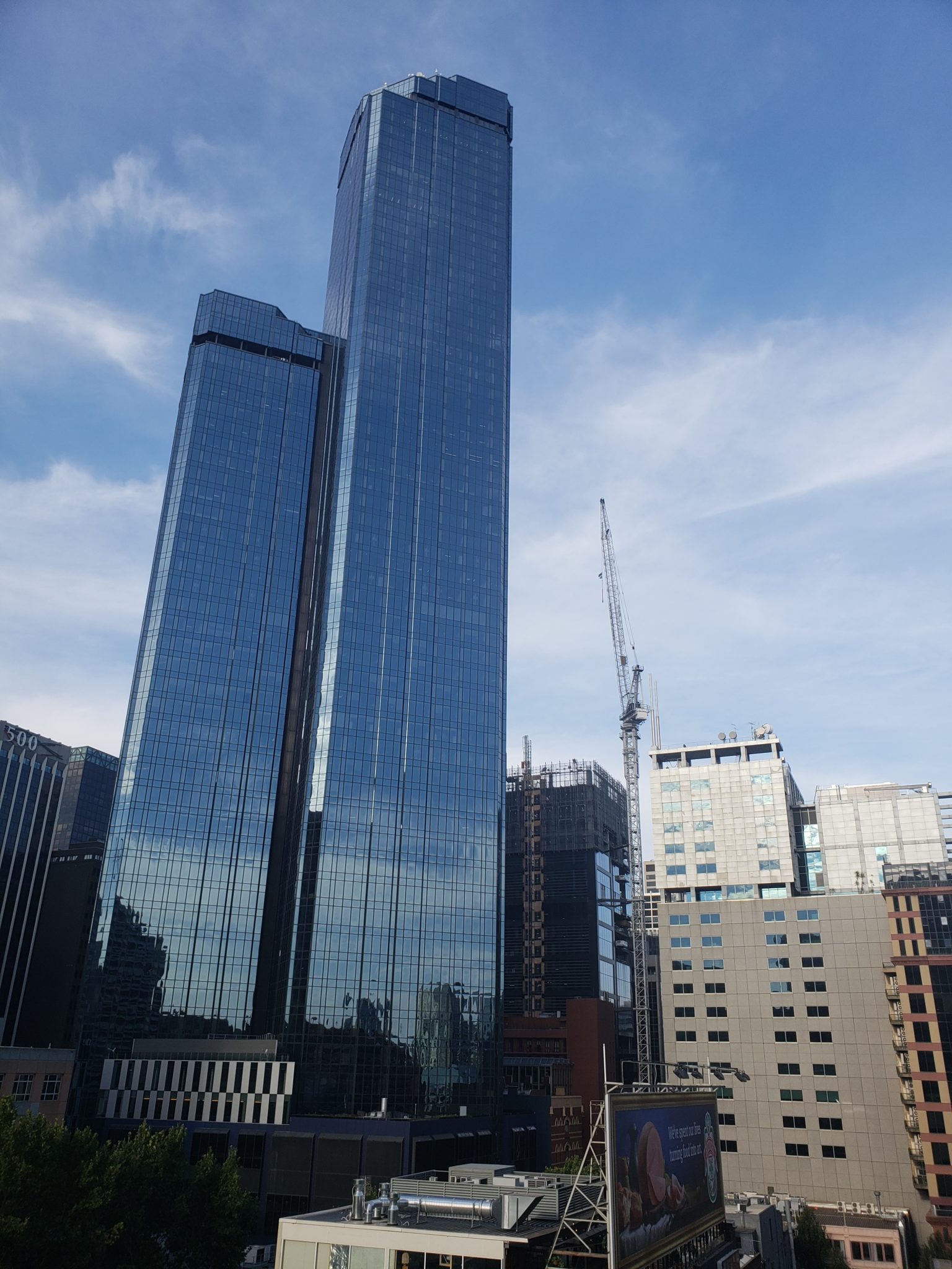 a tall buildings with a crane in the background