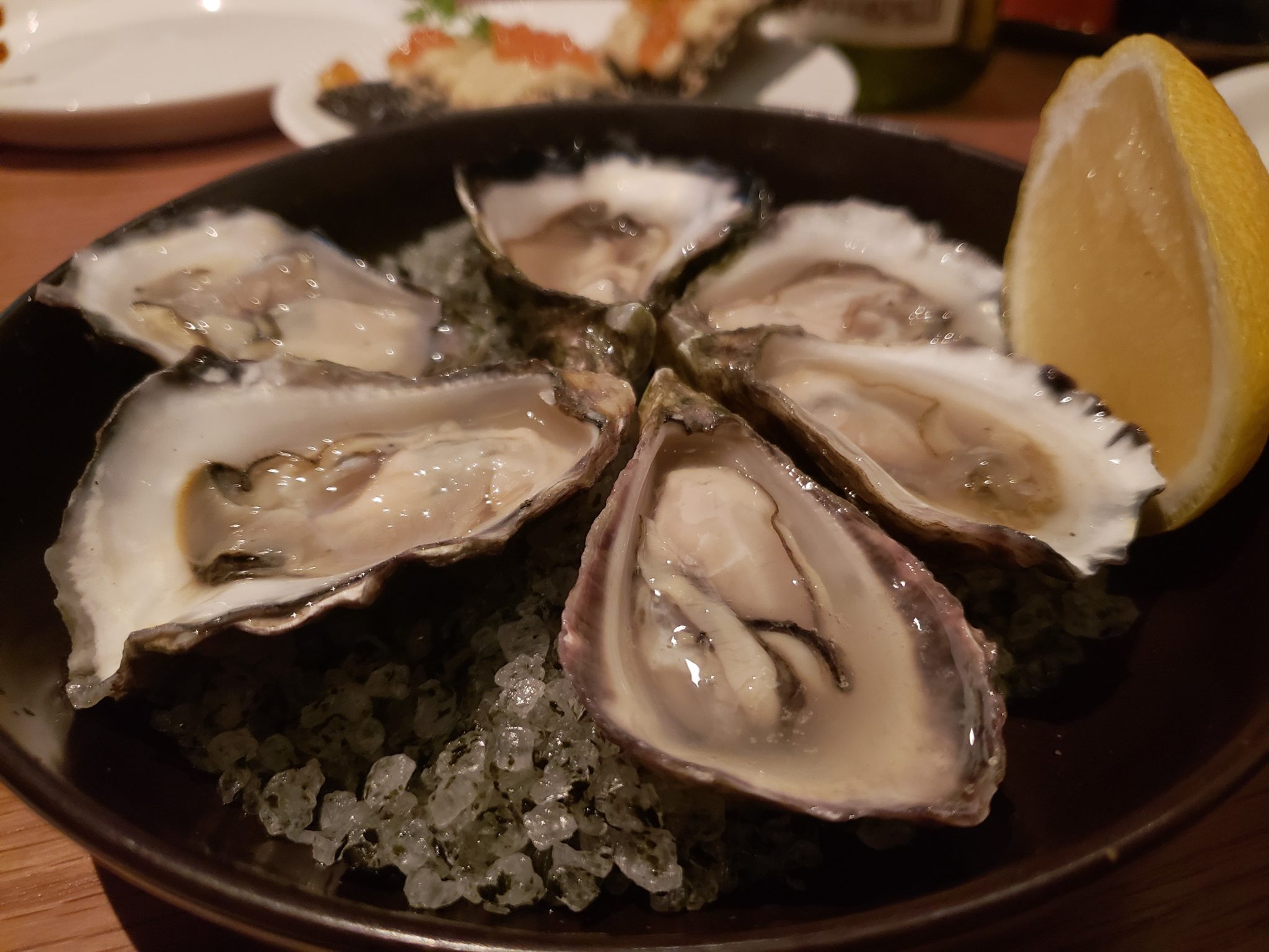 a plate of oysters and a lemon