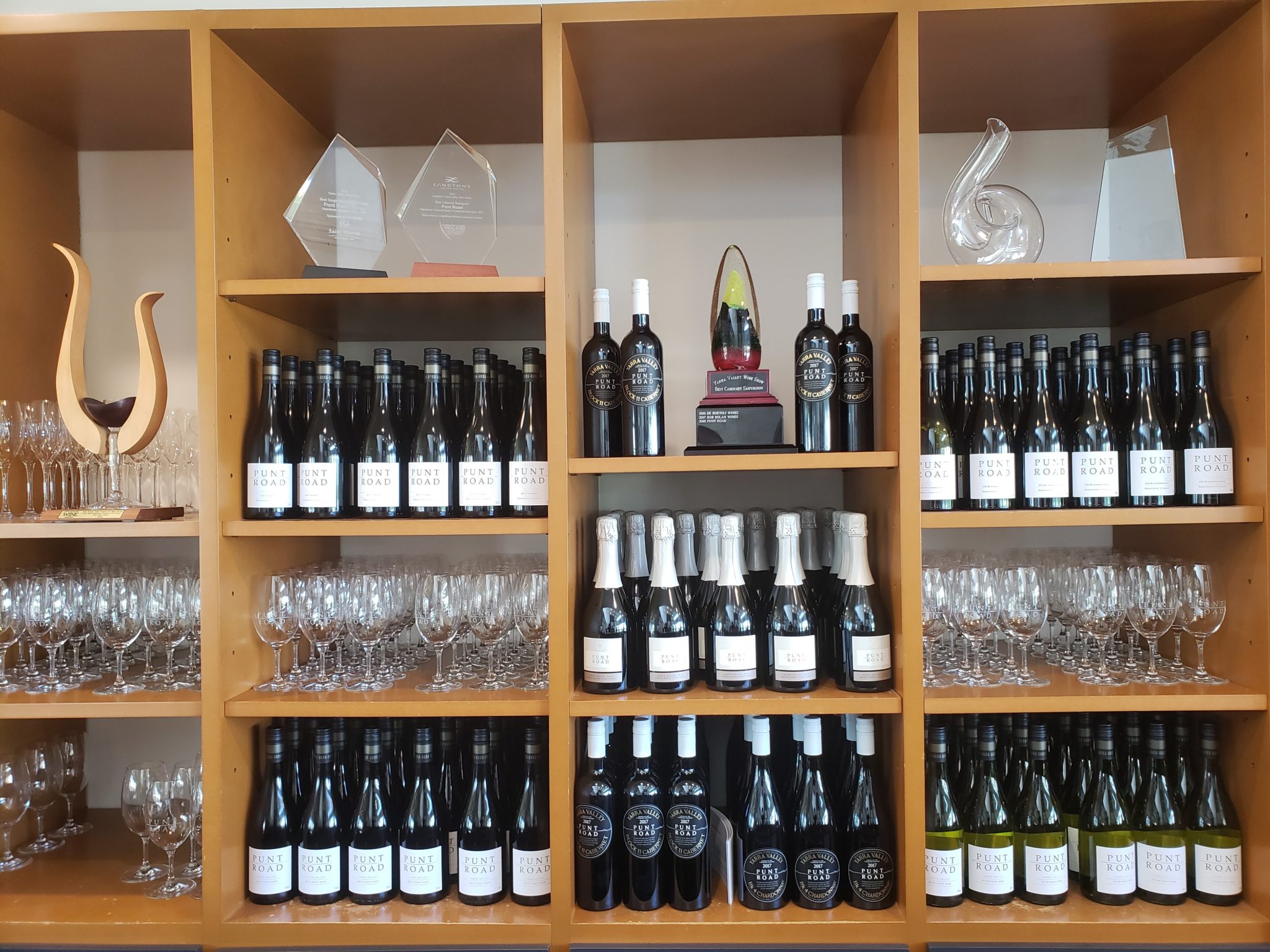 shelves of wine bottles and glasses on shelves