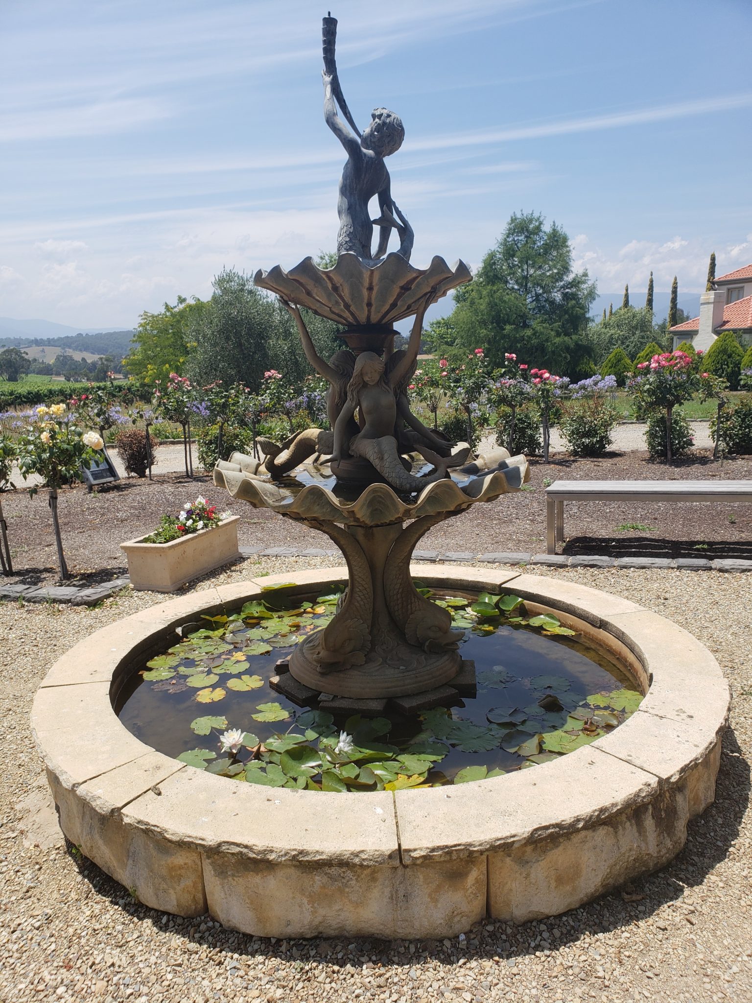 a fountain with a statue of a child and a boy in the middle