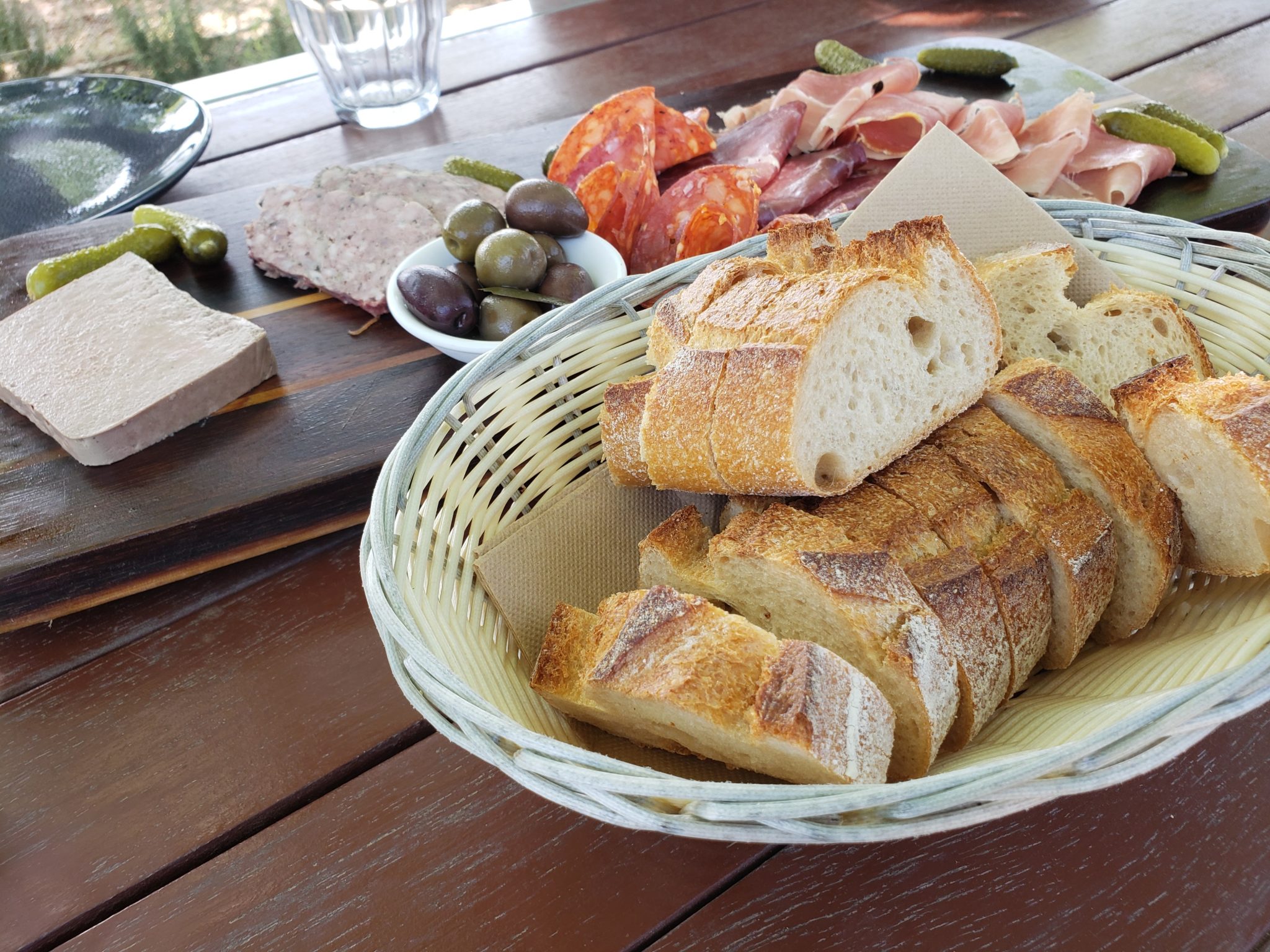 a basket of bread and meat on a table