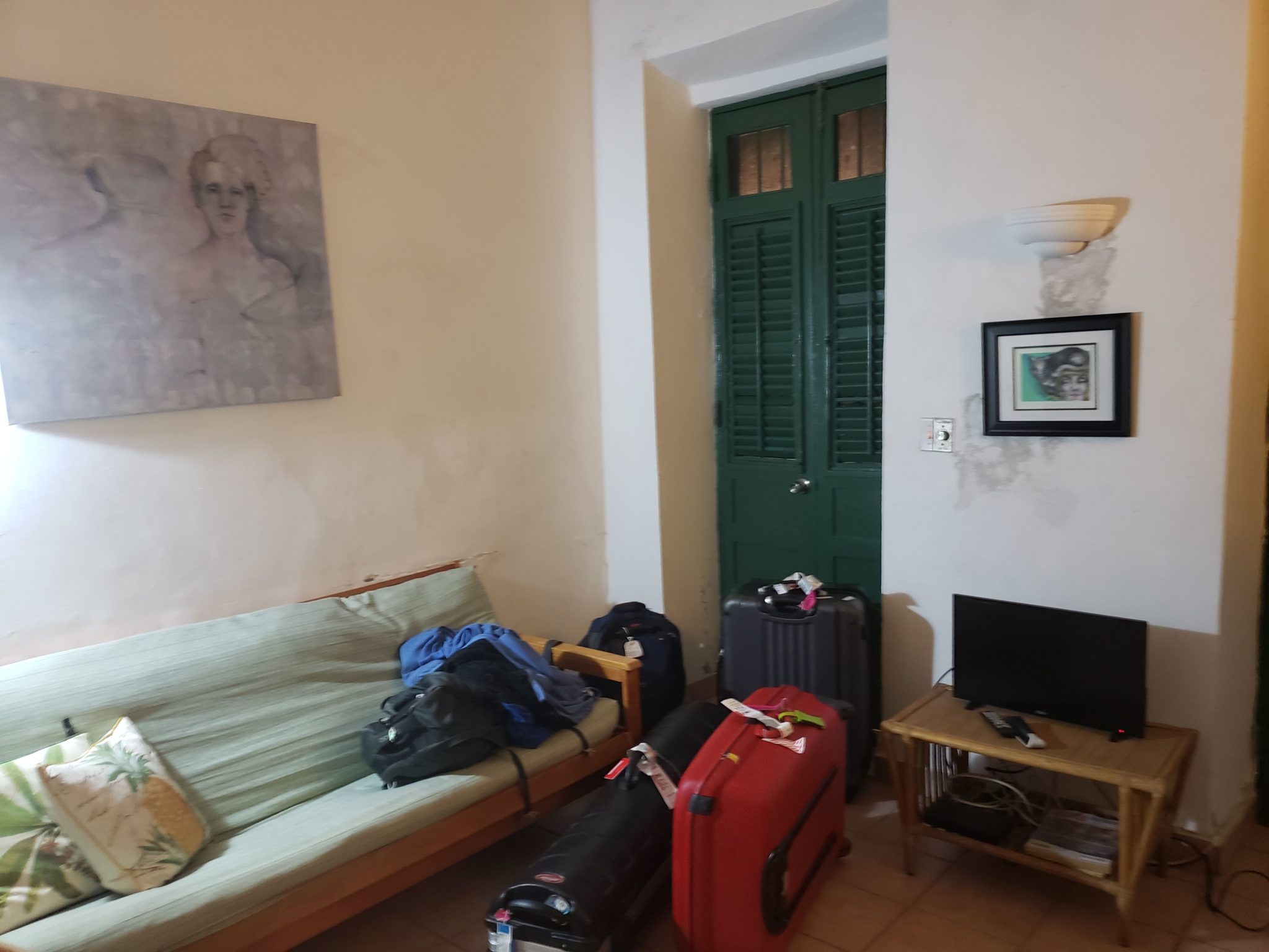 a room with a couch and luggage