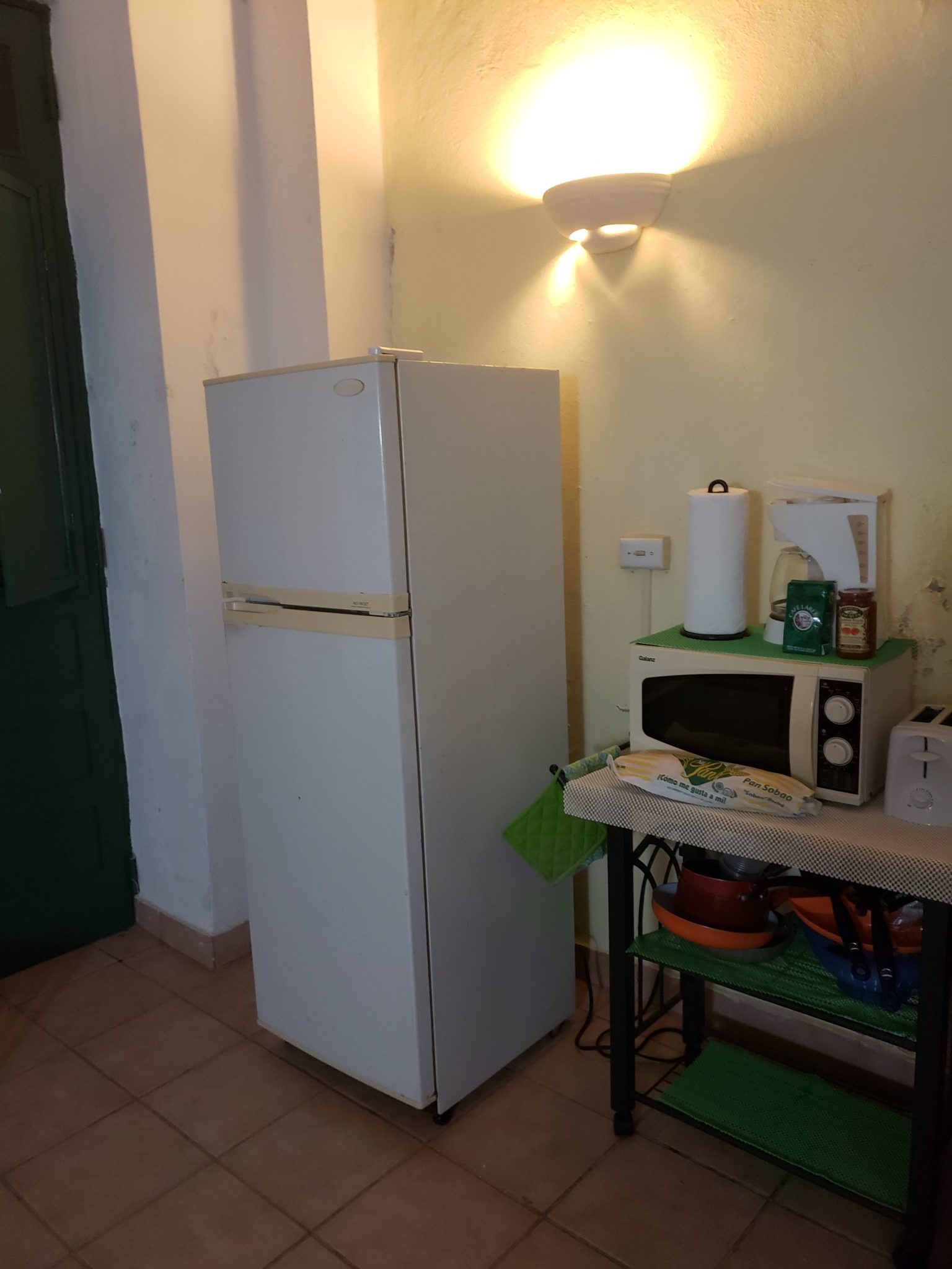 a refrigerator and microwave in a kitchen