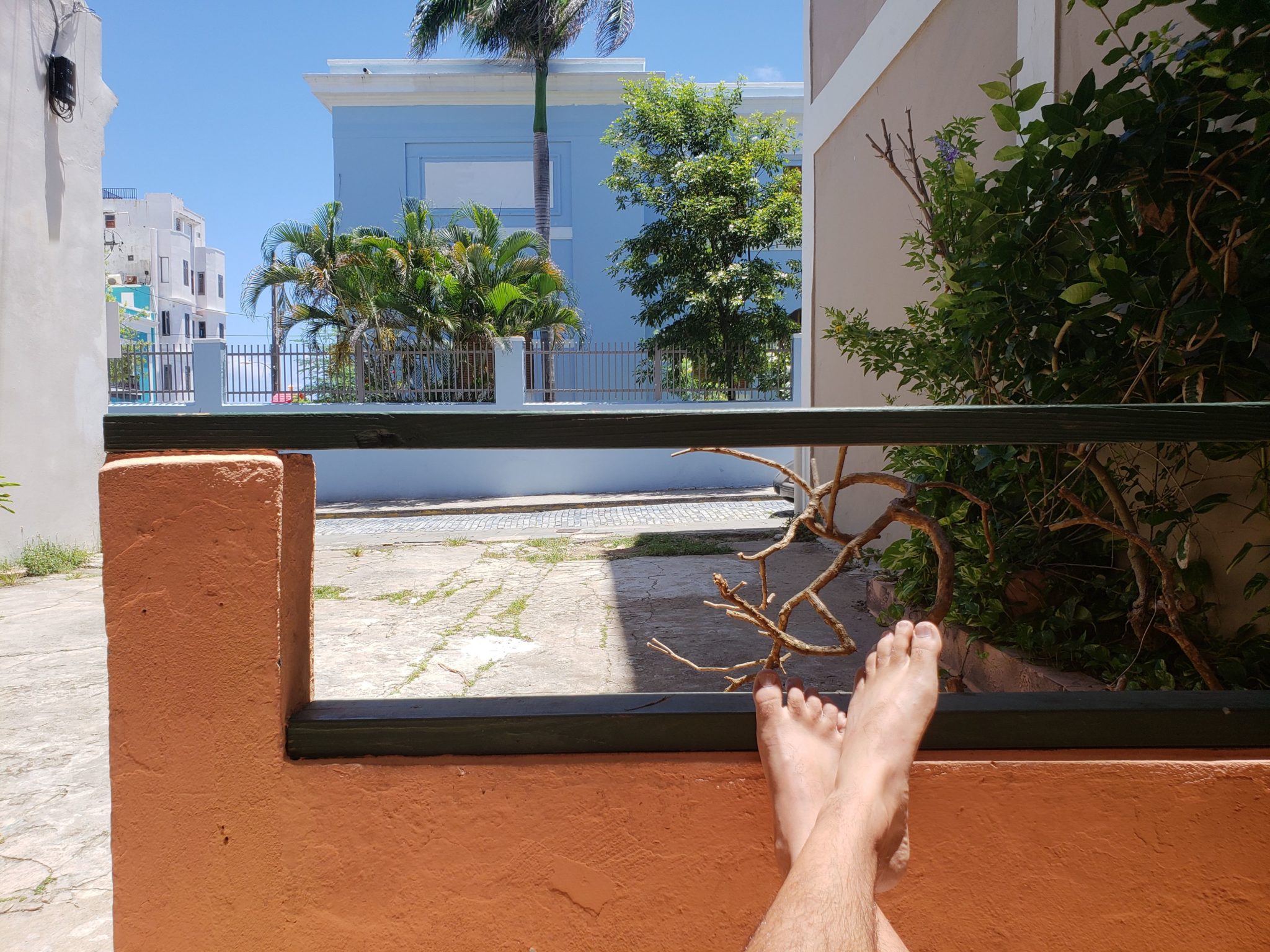 a person's feet on a balcony