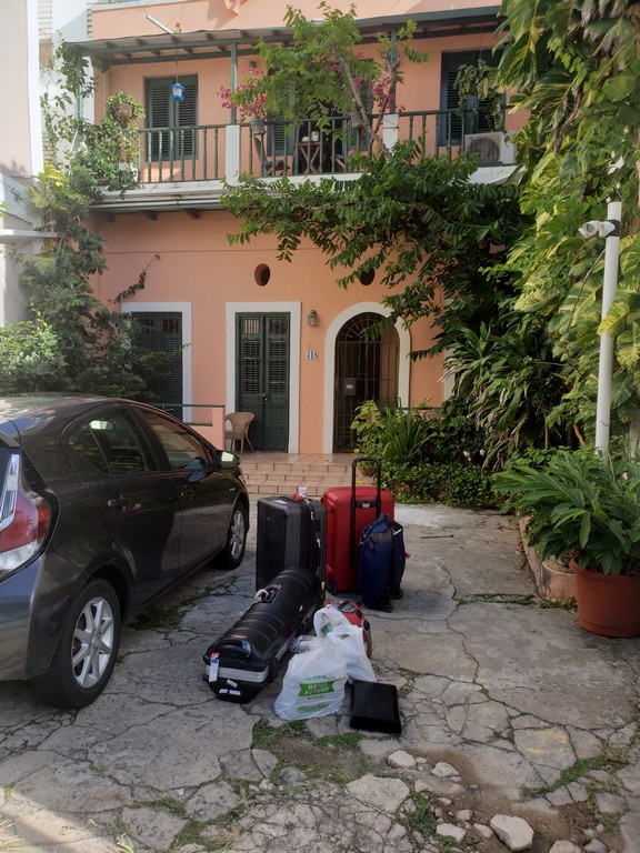 a car parked outside a house with luggage