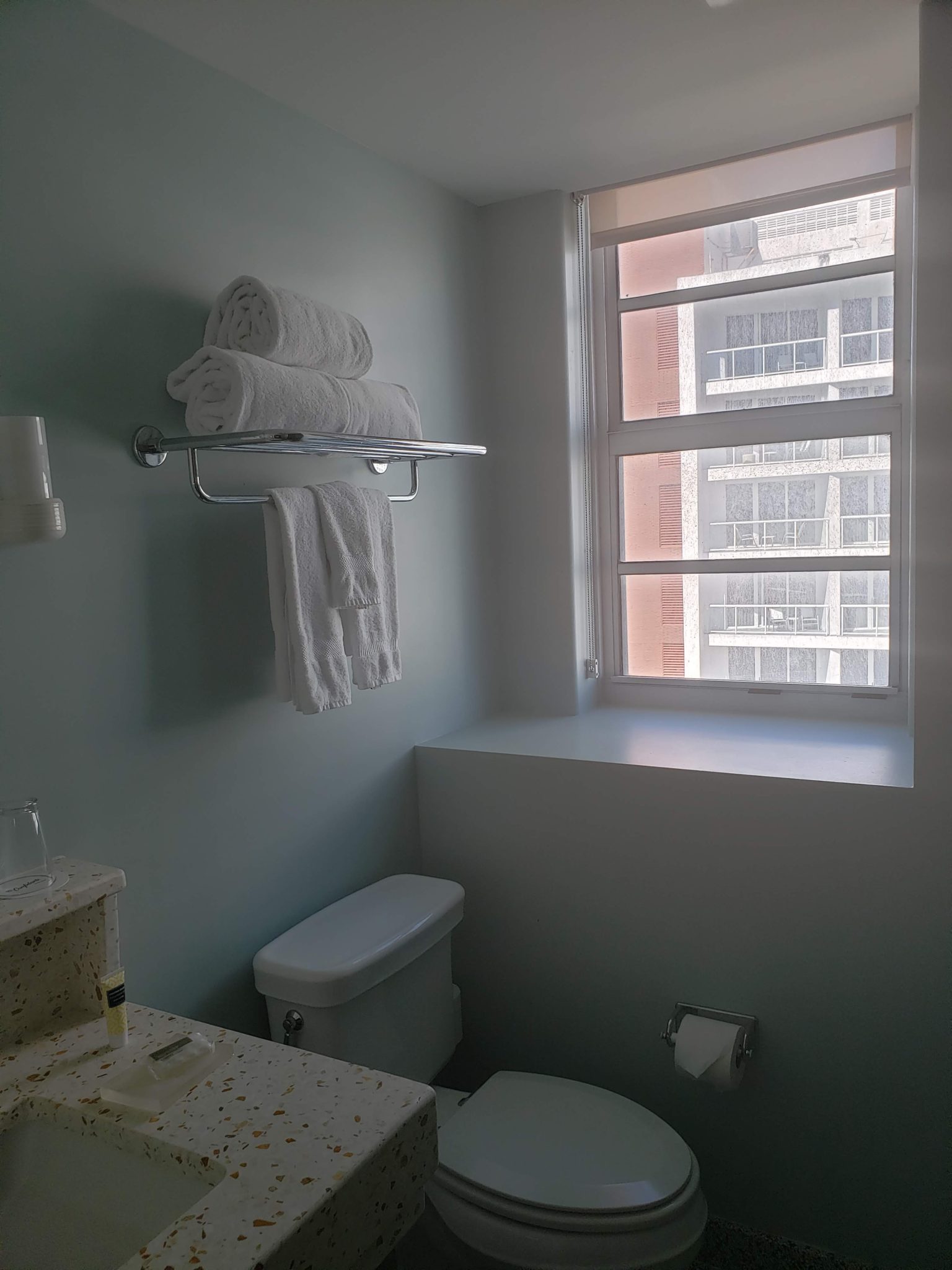 a bathroom with a window and towels