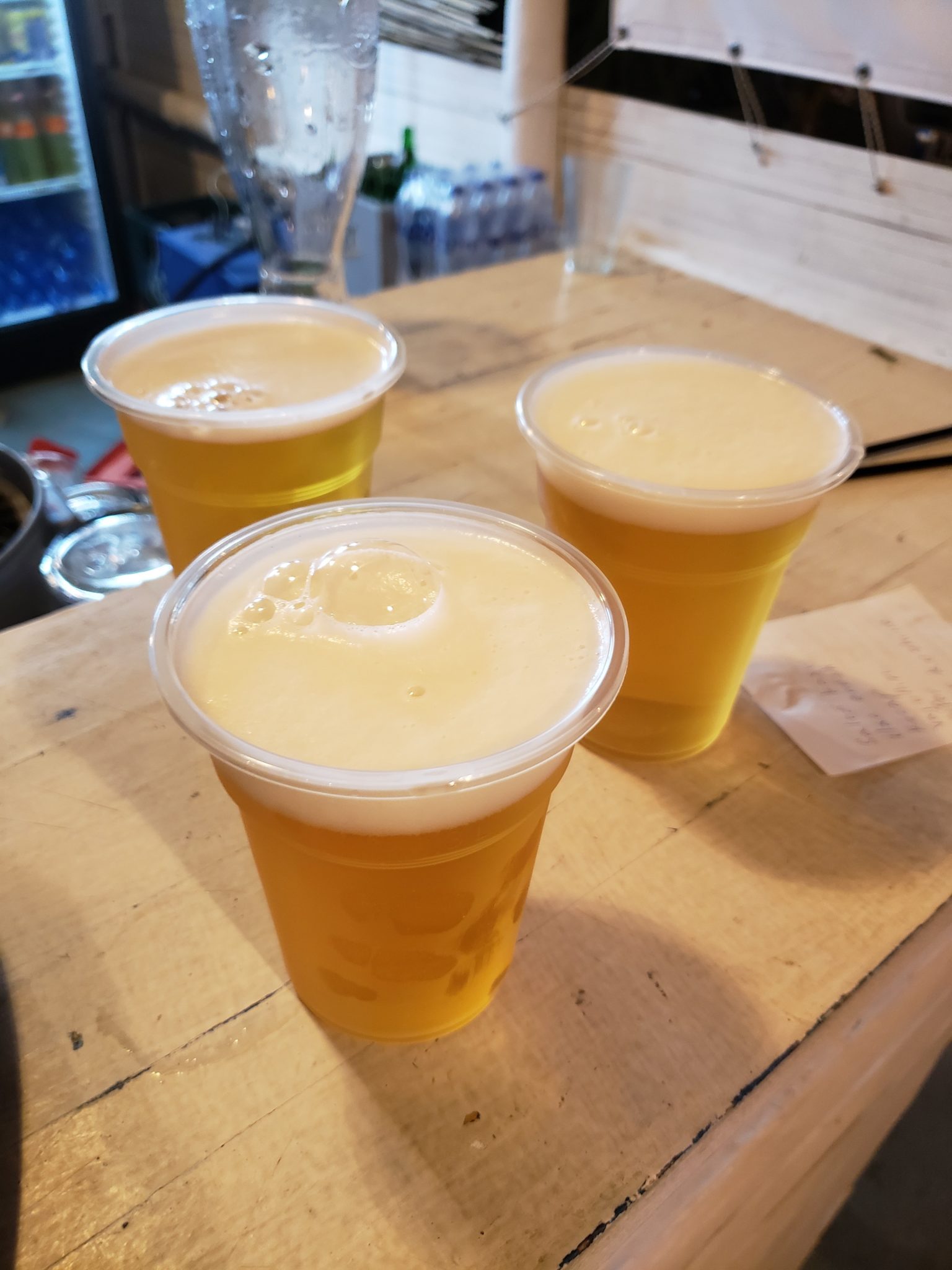 a group of plastic cups of beer