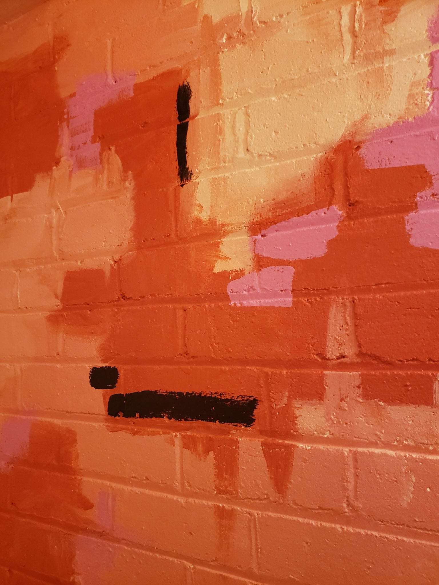 a brick wall with paint on it