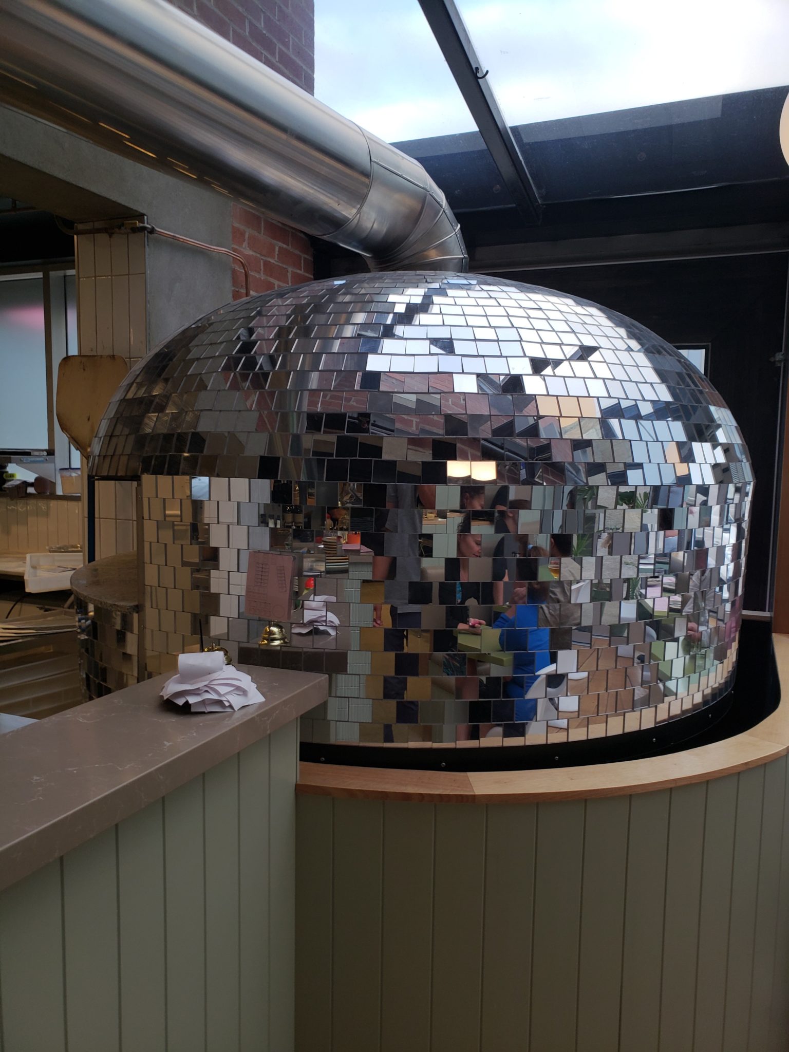 a mirror ball with a person in the background