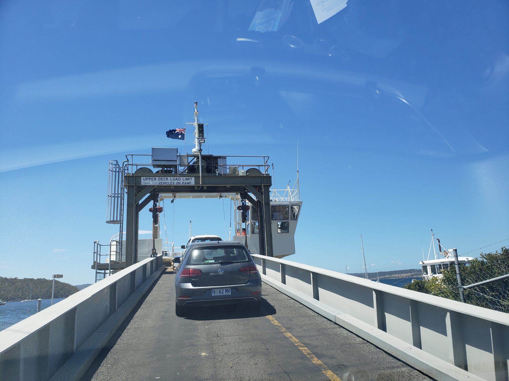 cars on a bridge with a ferry
