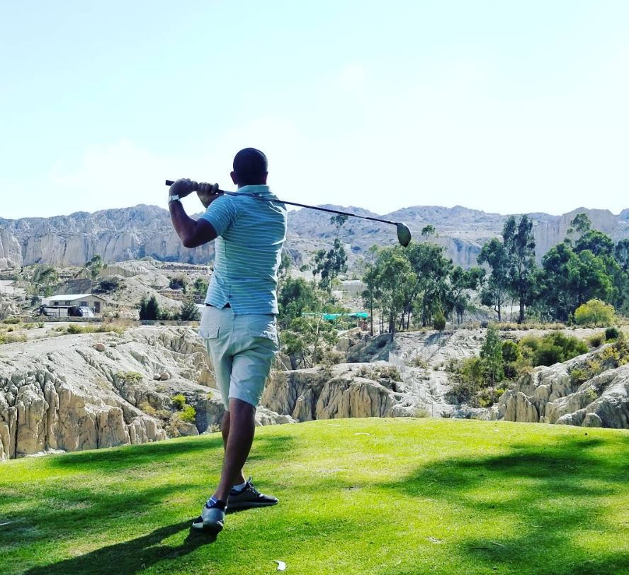 a man swinging a golf club