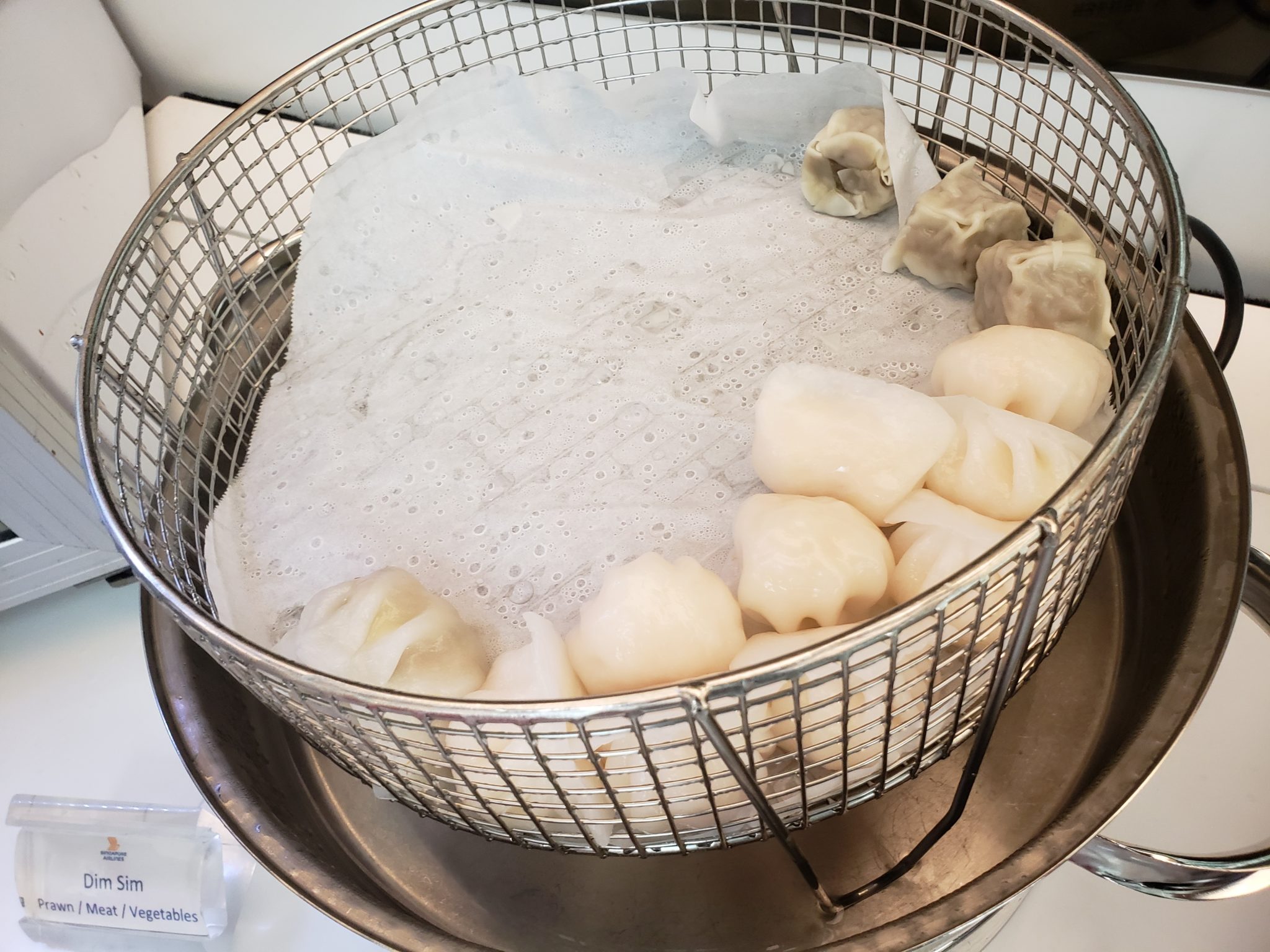 a basket of dumplings in a frying pan
