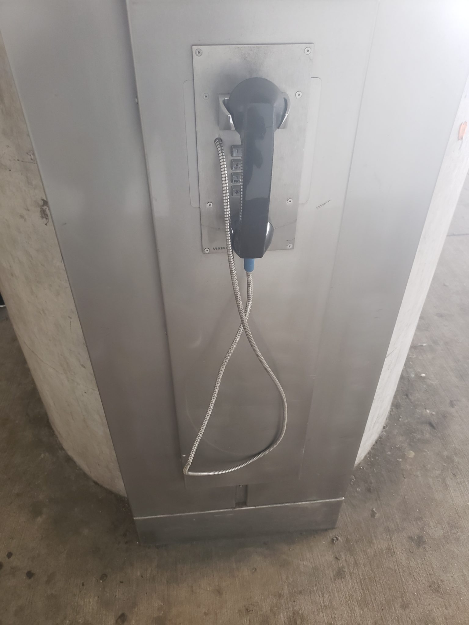 a telephone booth with a cord attached to it