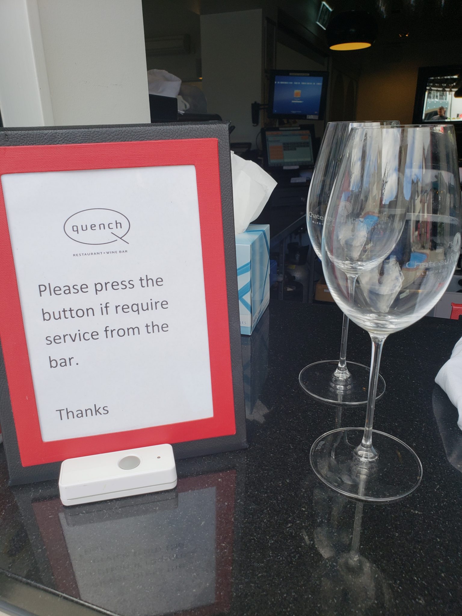 a sign next to a wine glass