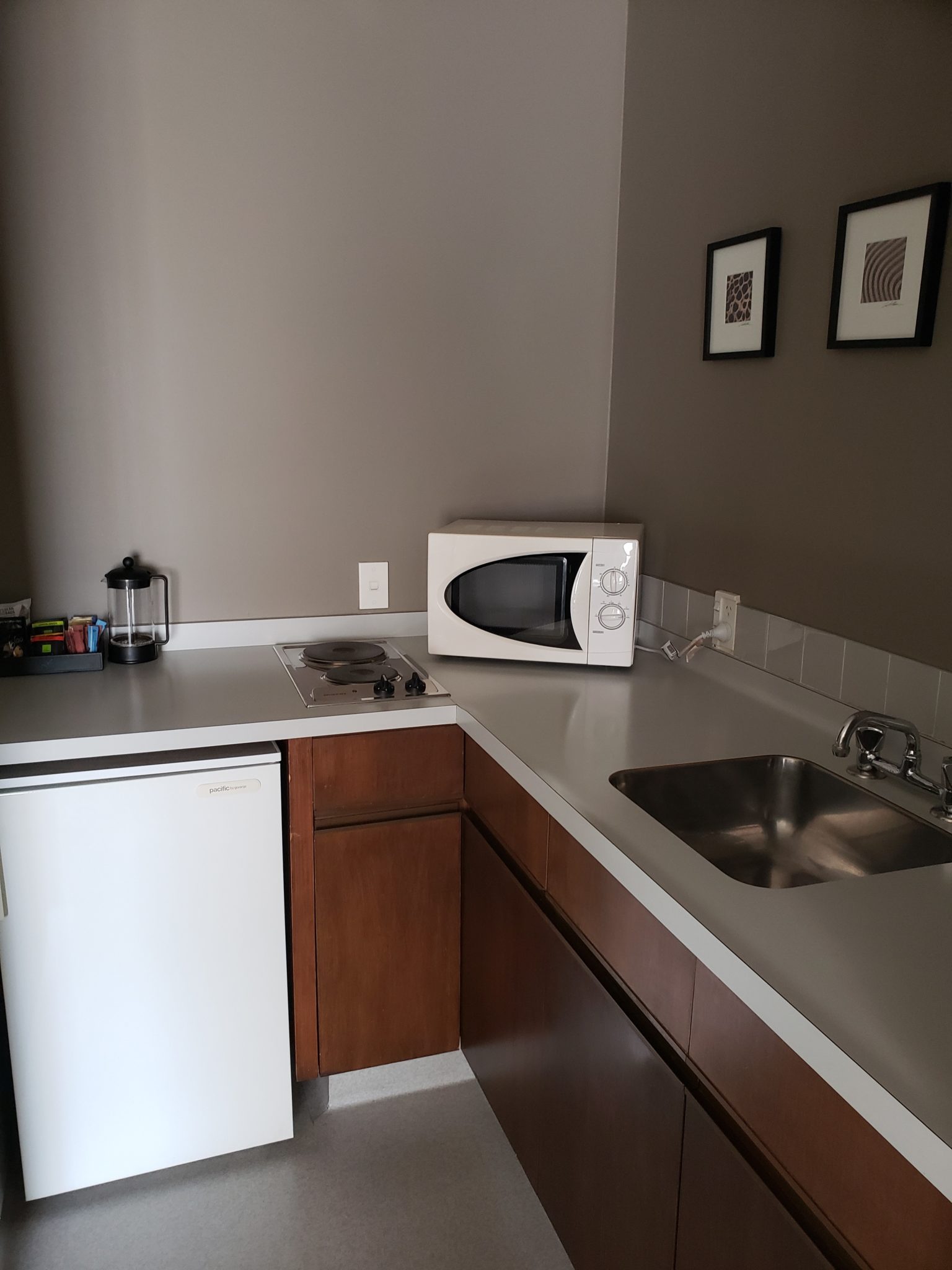 a kitchen with a microwave and a sink