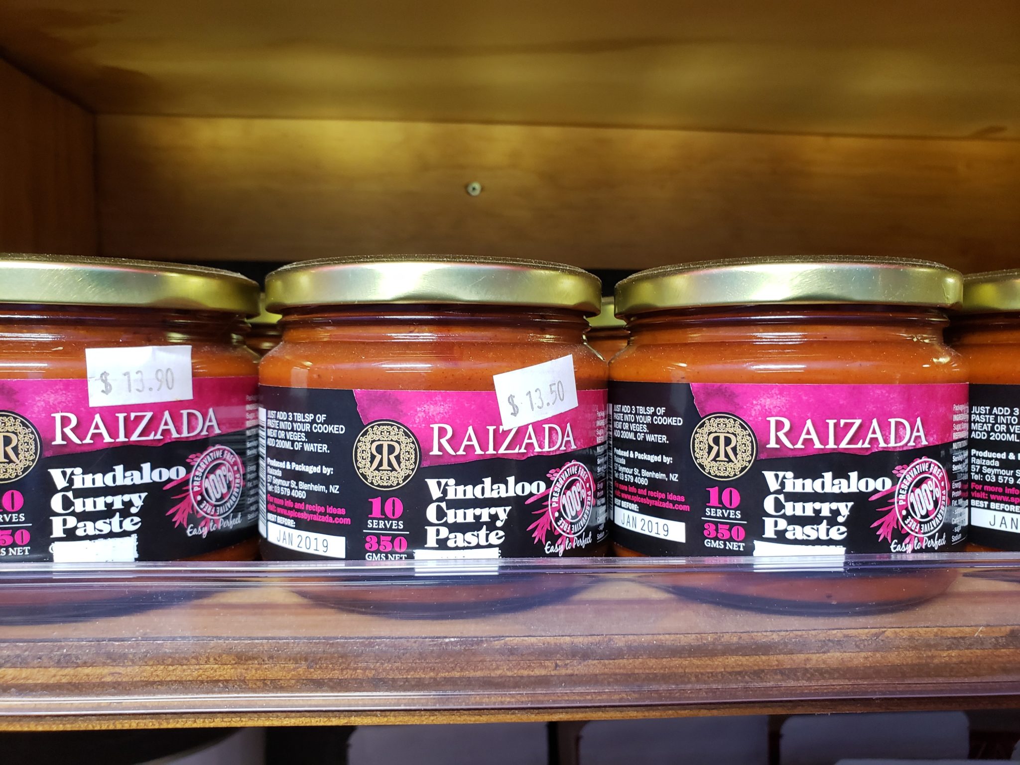 a group of jars of sauce on a shelf