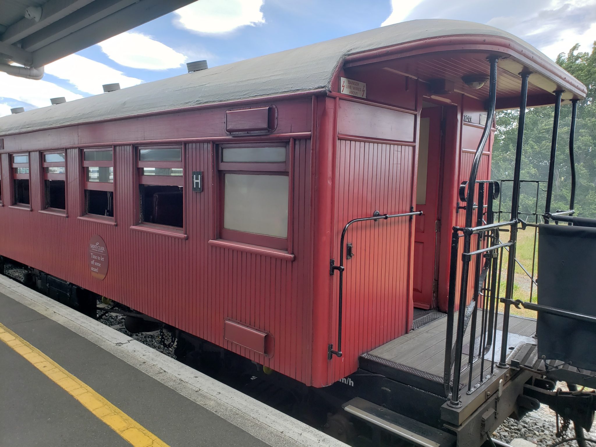 a red train car at a station