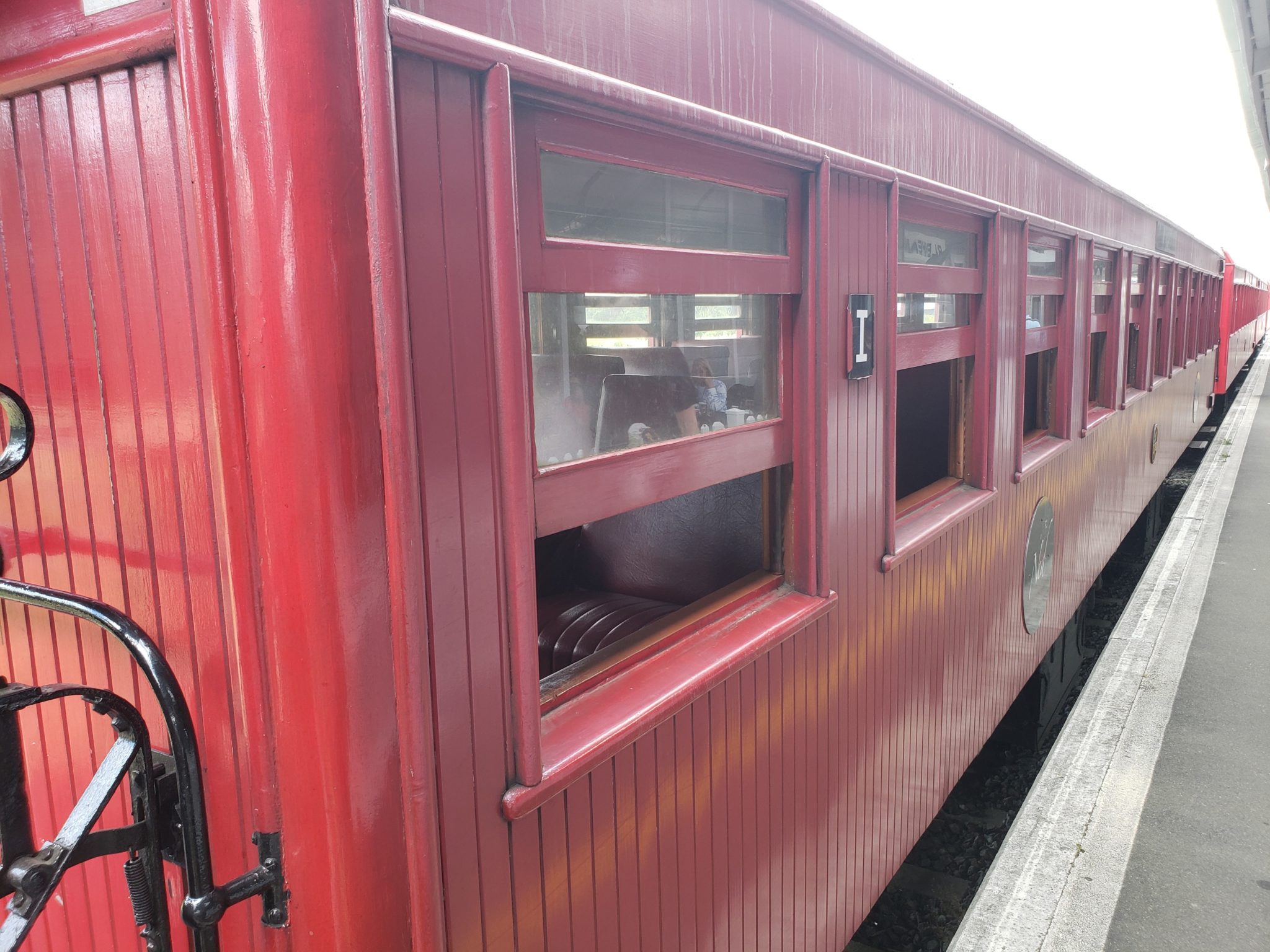 a red train car with windows