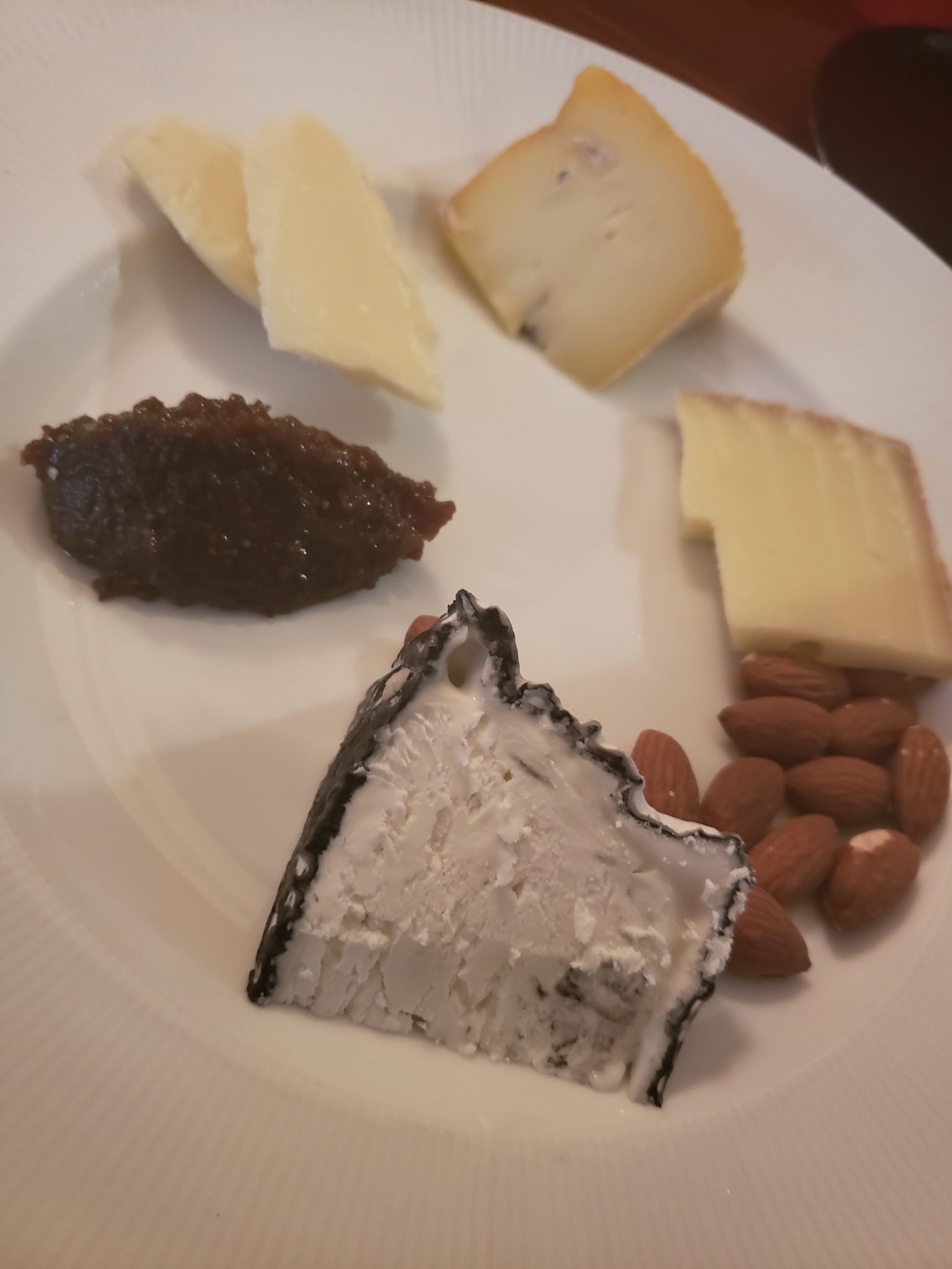 a plate of cheese and nuts