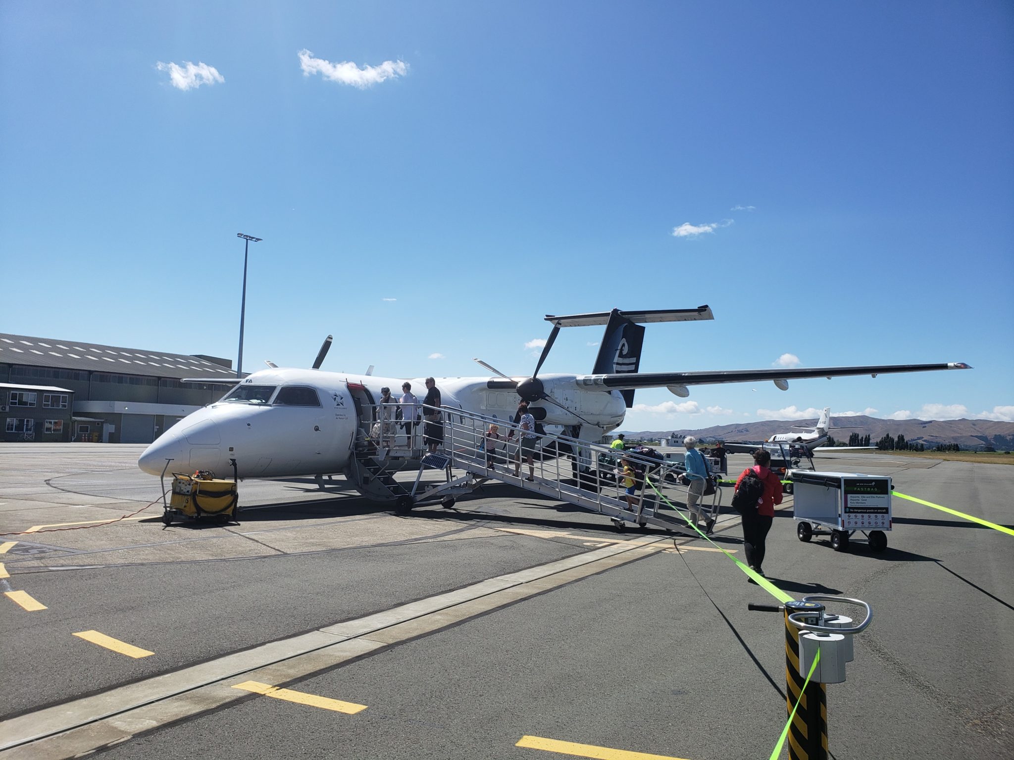 a plane with people boarding it
