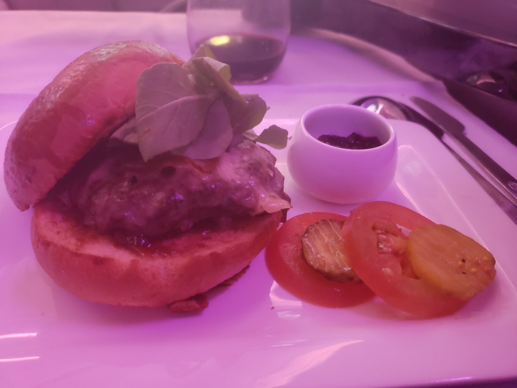 a burger and tomatoes on a plate