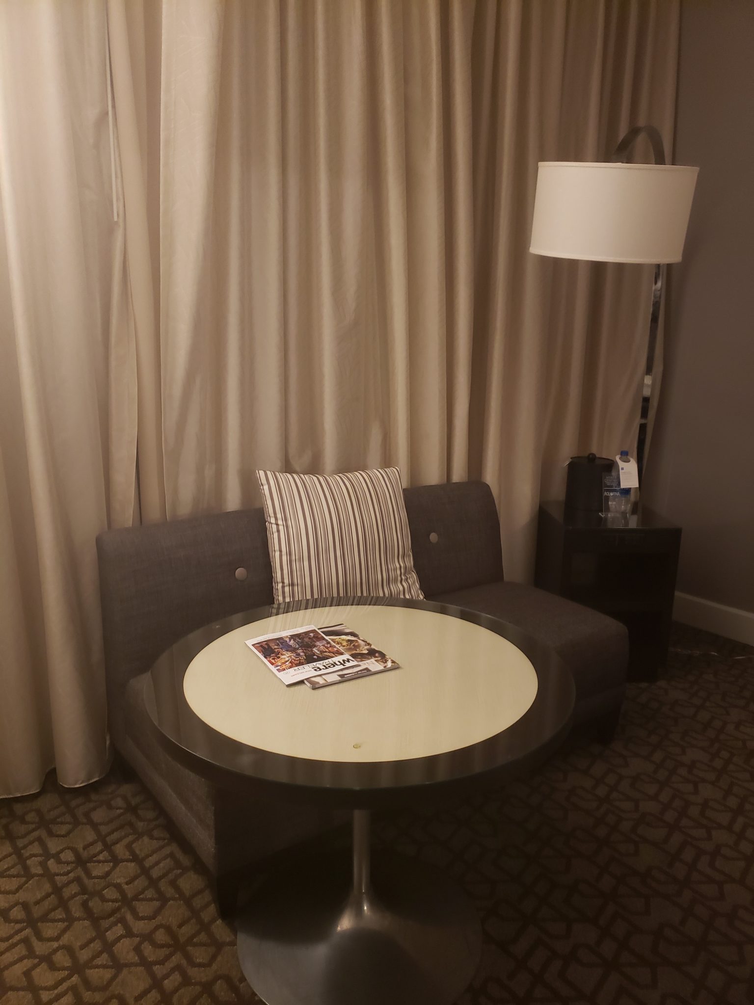 a couch with a table and lamp in a room