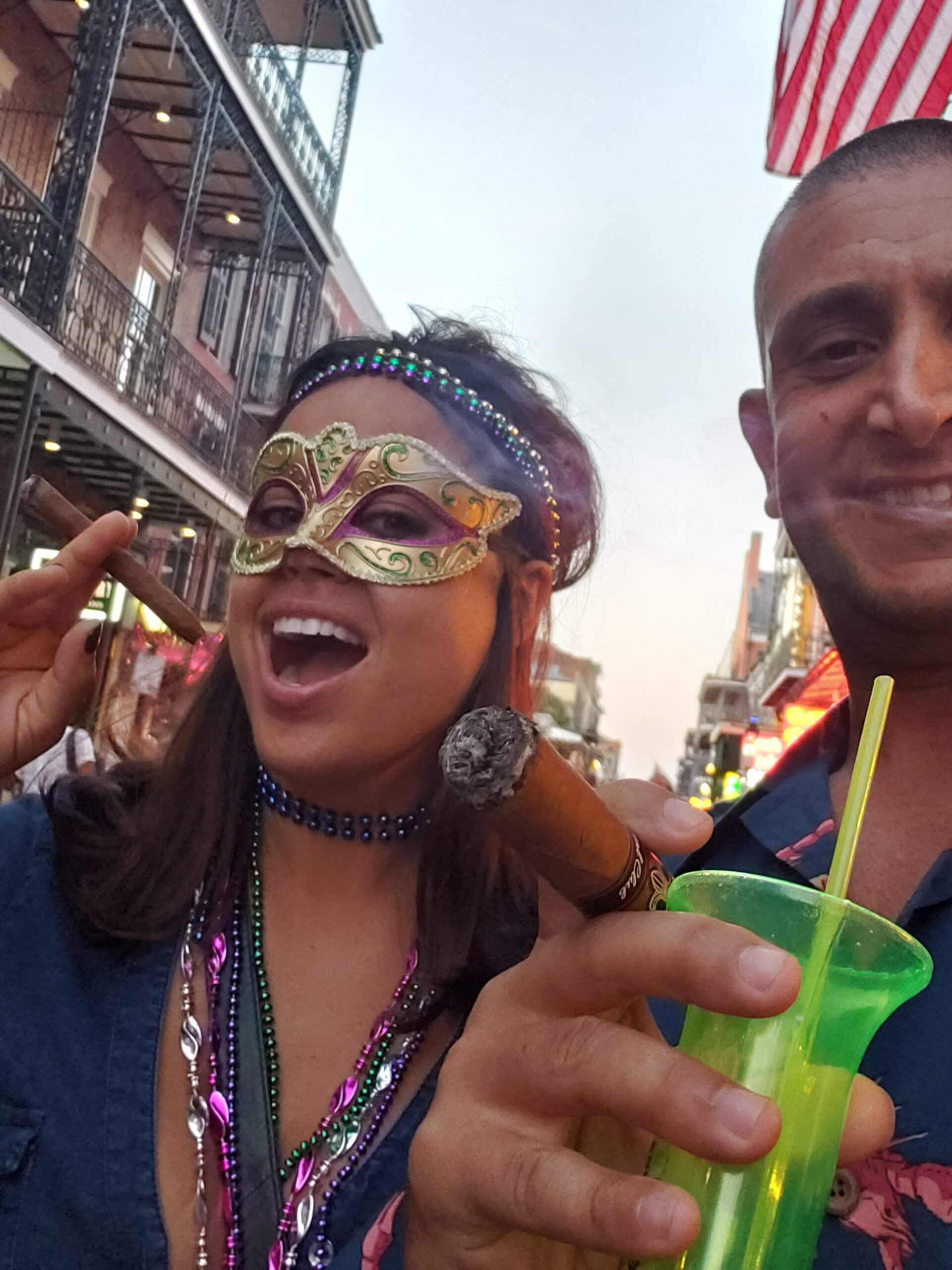 a man and woman with a cigar and a drink