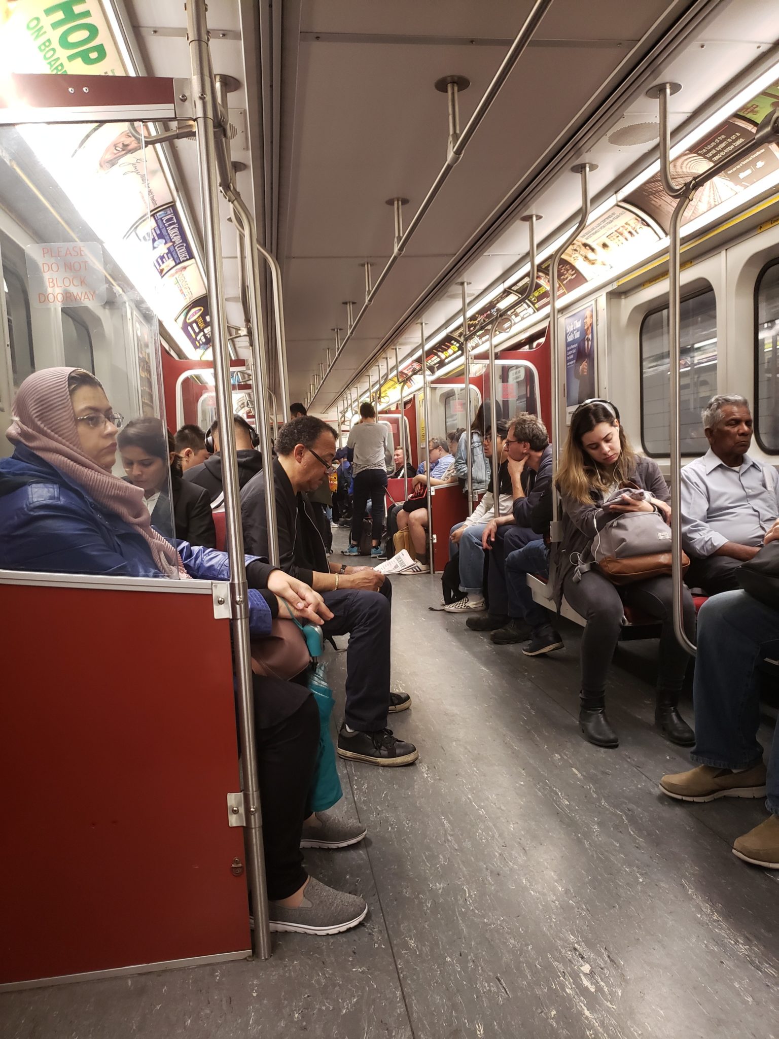 a group of people sitting on a subway car