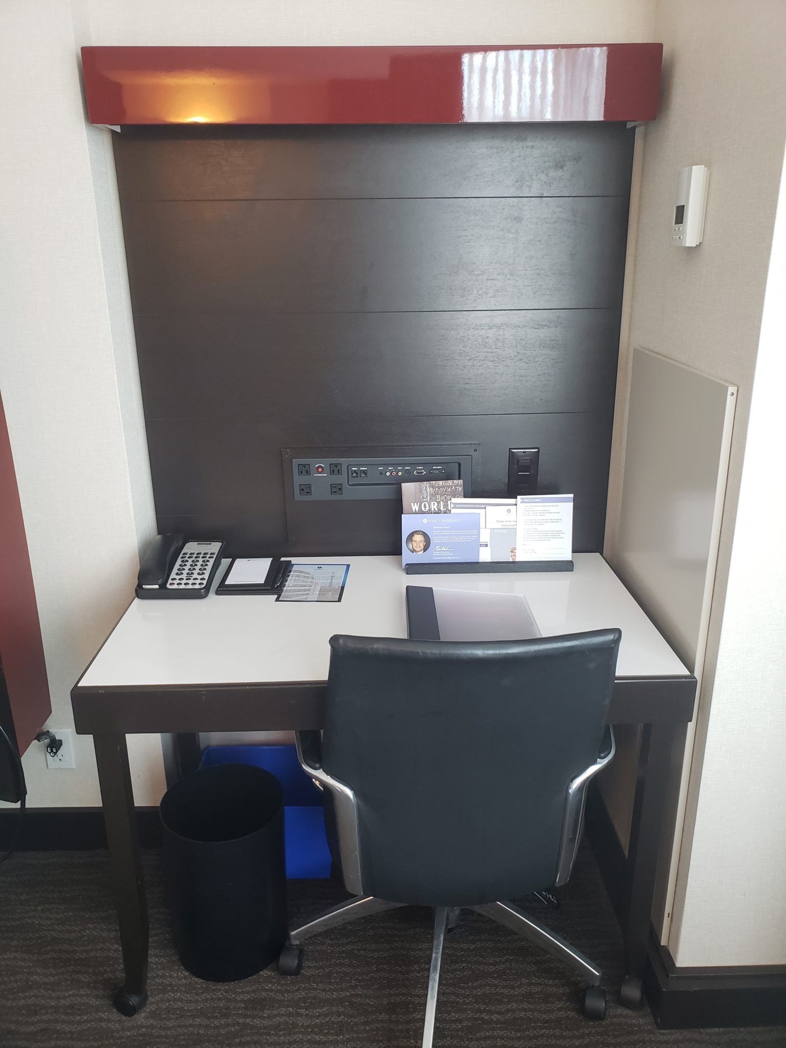 a desk with a chair and a phone on it