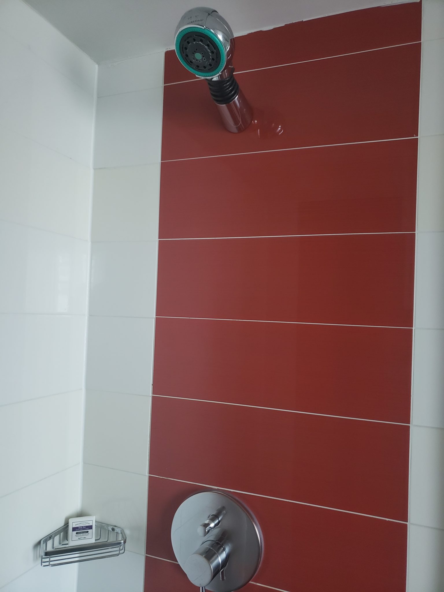 a shower head on a tile wall