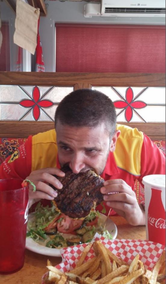 a man eating a burger