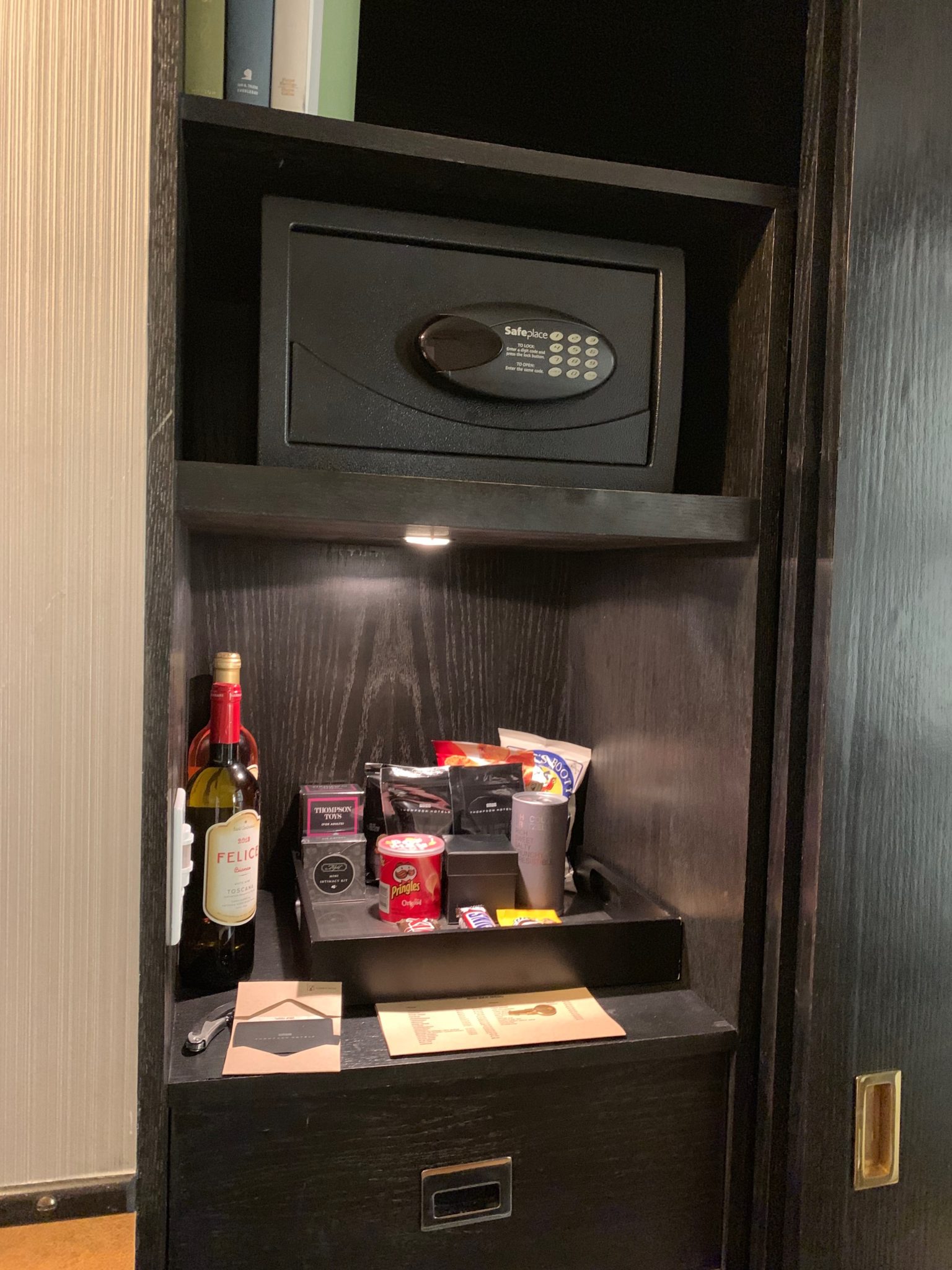 a black safe with food and a bottle of wine in it
