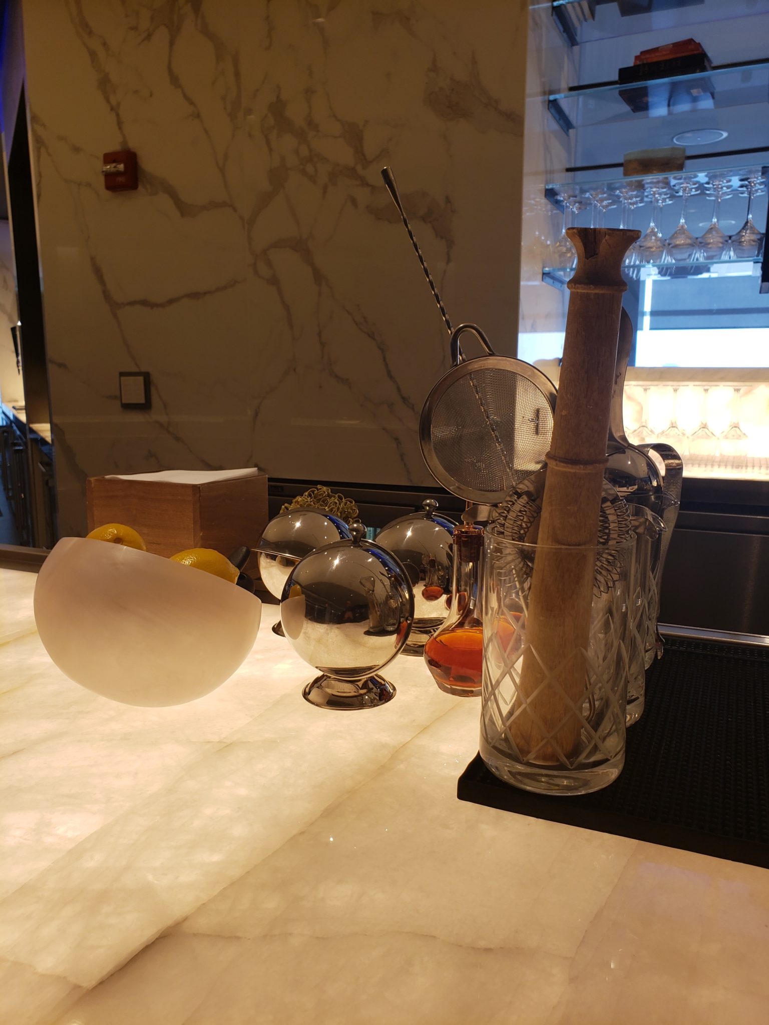 a bar counter with a glass and utensils
